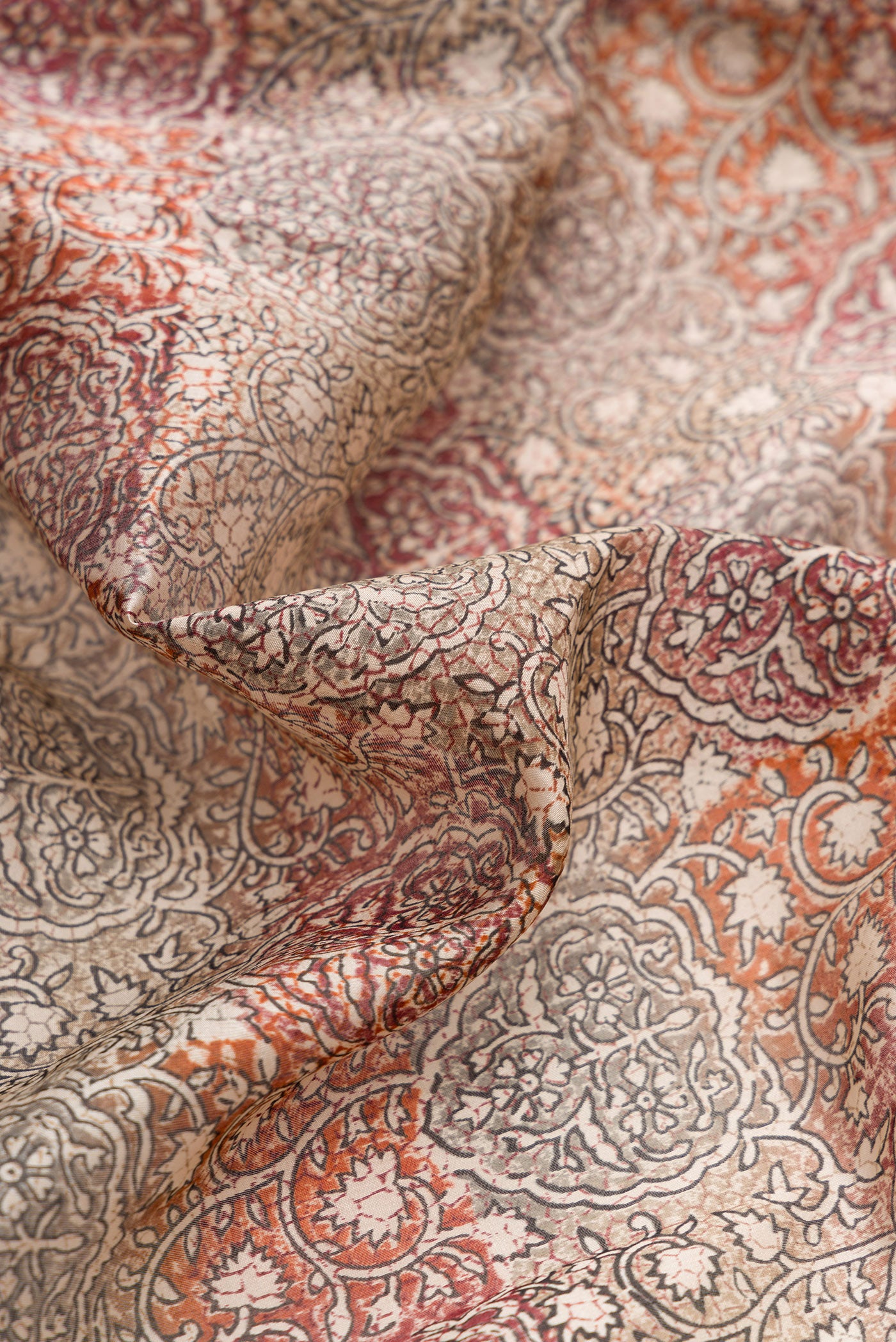 Close up of Grey Dual Tone Tussar Silk Saree with Printed design on the body and Printed Border.  displaying folds
