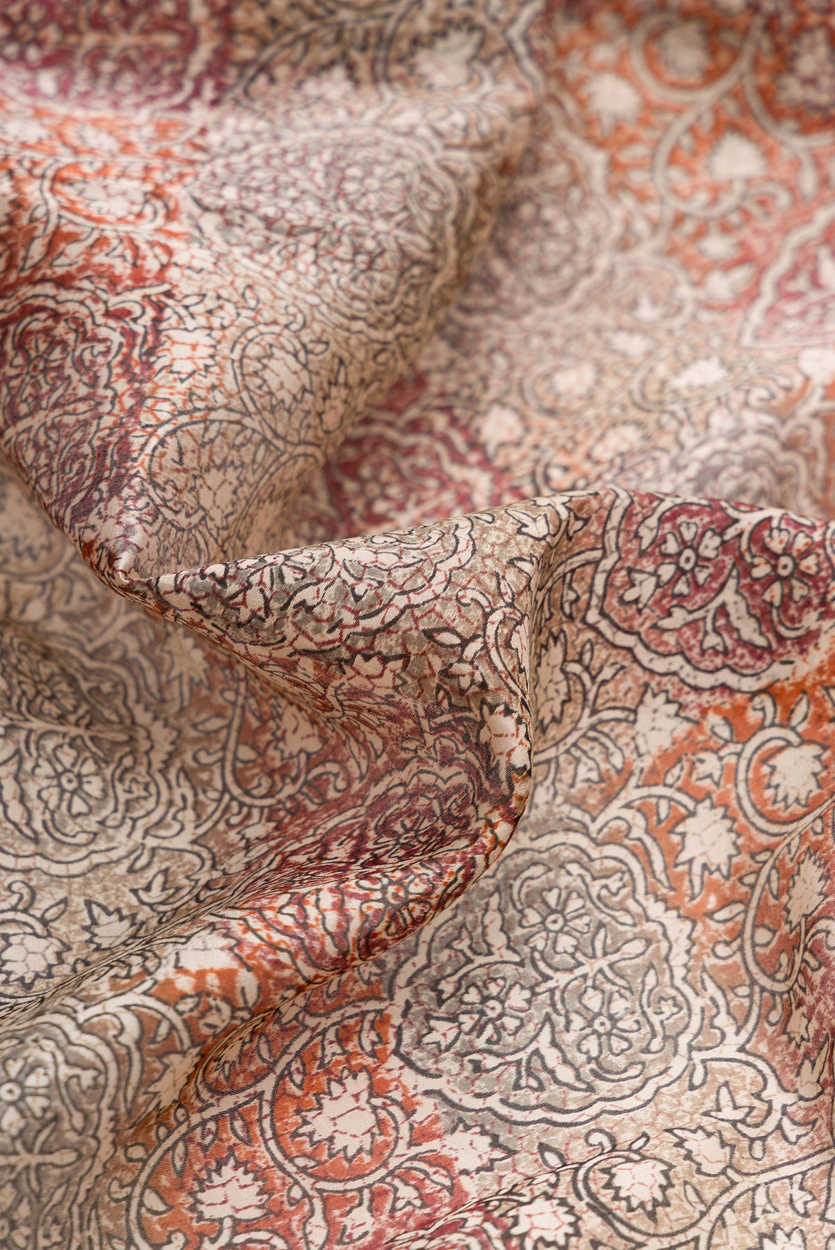 Close up of Grey Dual Tone Tussar Silk Saree with Printed design on the body and Printed Border.  displaying folds