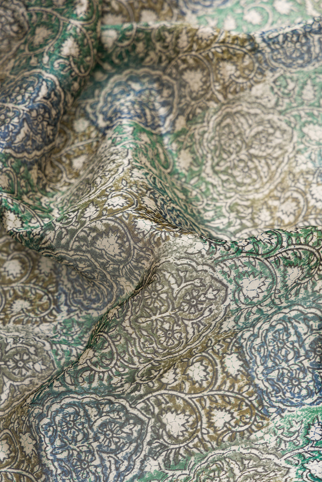 Close up of Grey Dual Tone Tussar Silk Saree with Printed design on the body and Printed Border.  displaying folds