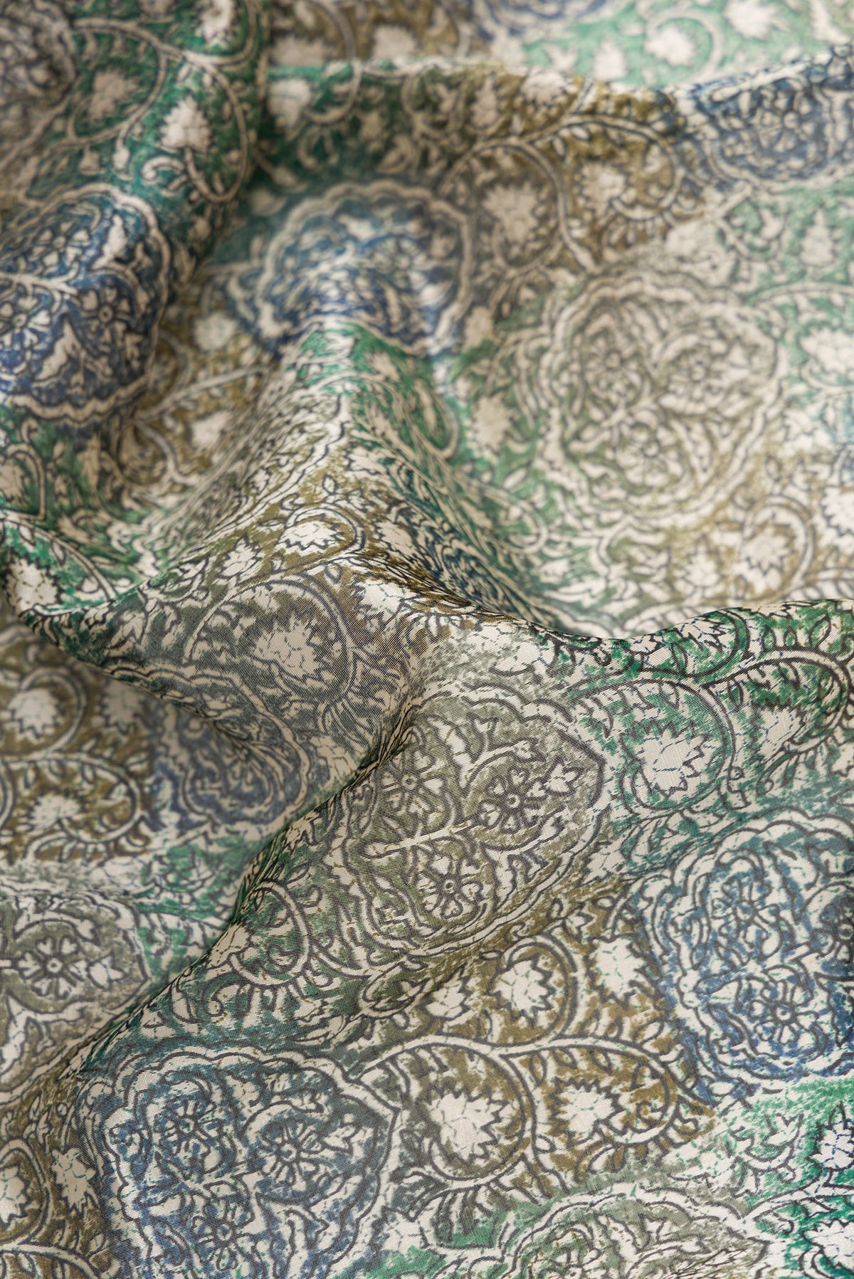 Close up of Grey Dual Tone Tussar Silk Saree with Printed design on the body and Printed Border.  displaying folds