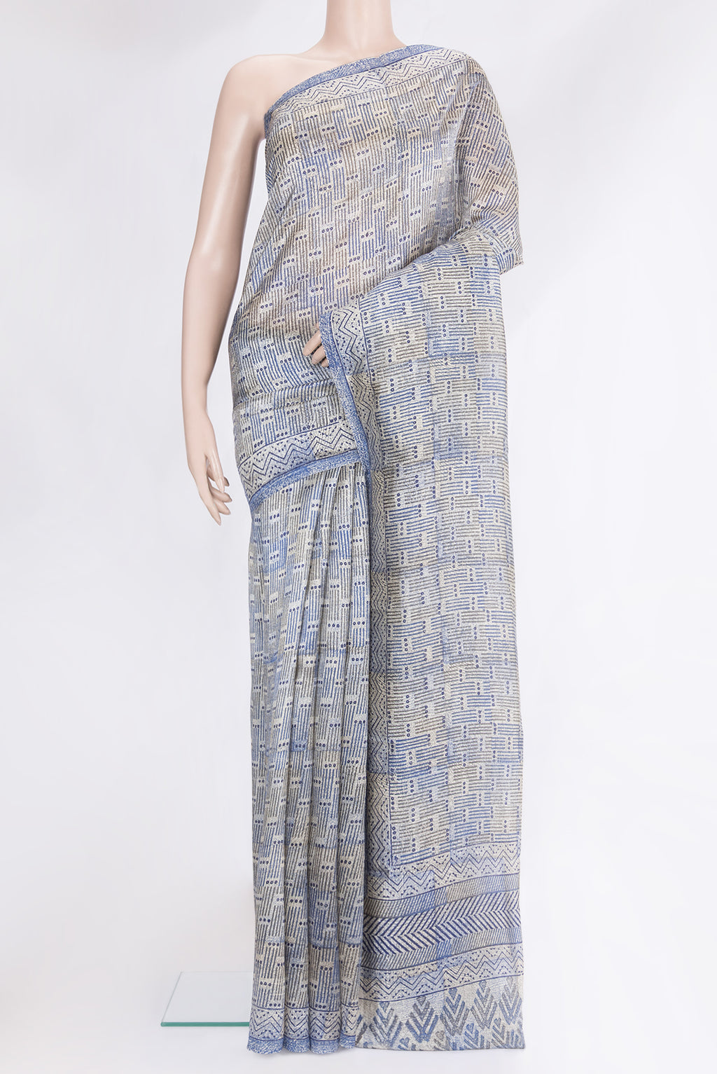 Beige Tussar Silk Saree with Printed design on the body and Printed Border.  displayed on a mannequin