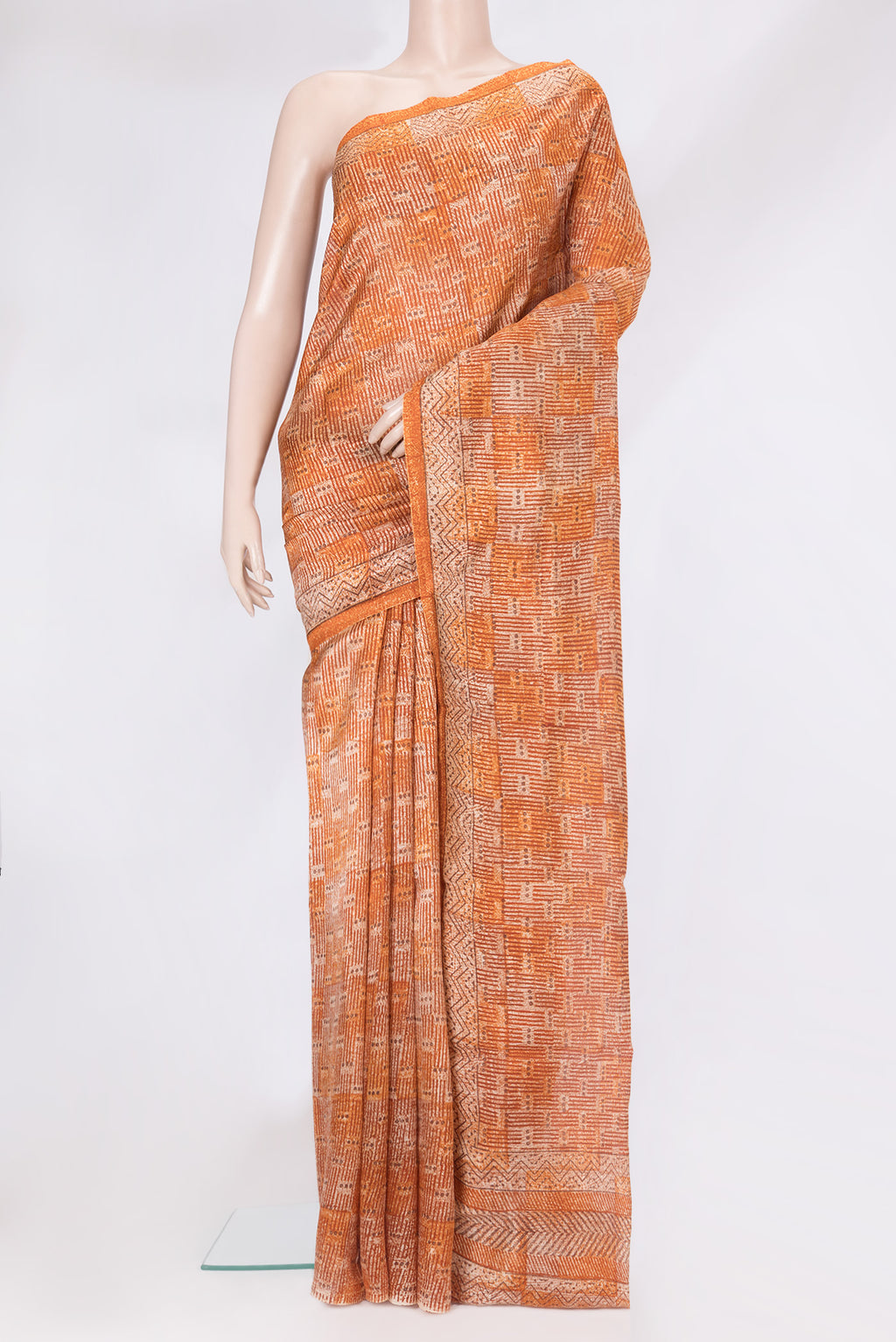 Brick Orange Tussar Silk Saree with Printed design on the body and Printed Border.  displayed on a mannequin
