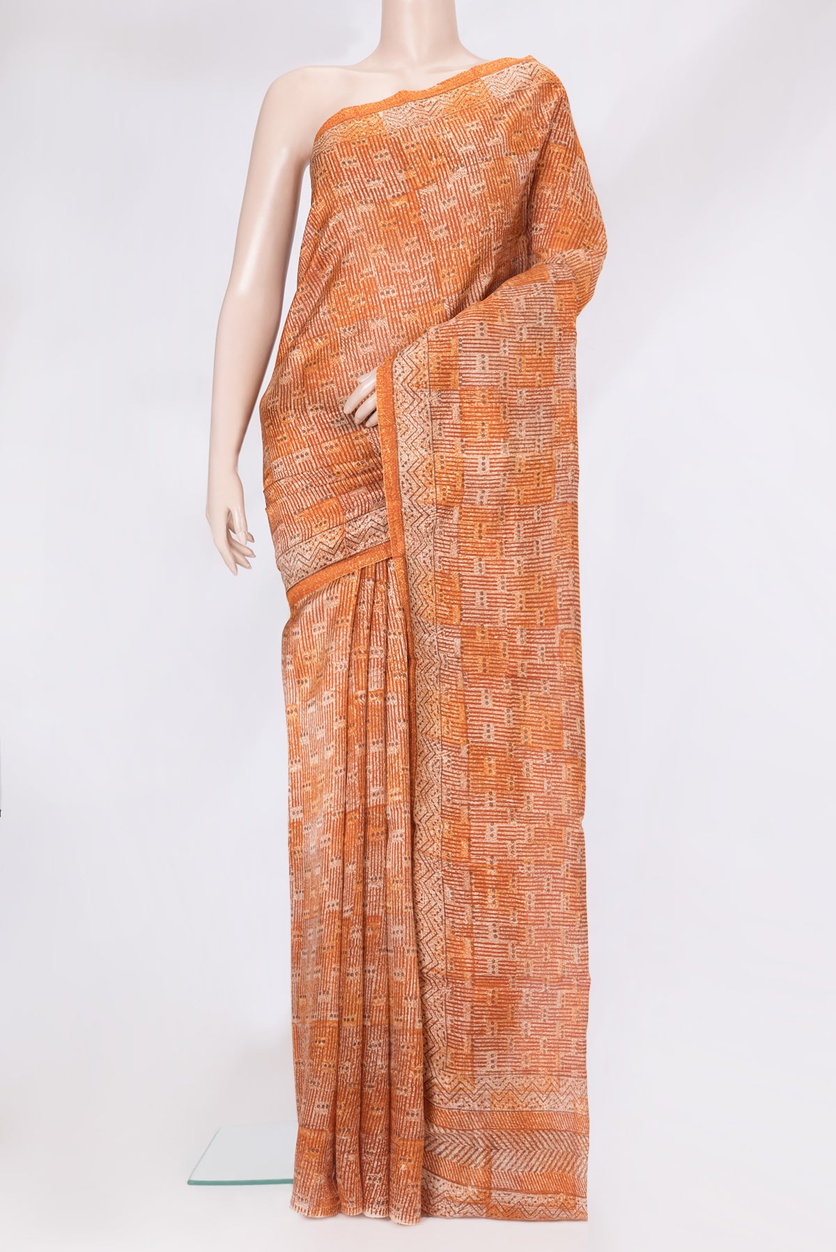 Brick Orange Tussar Silk Saree with Printed design on the body and Printed Border.  displayed on a mannequin
