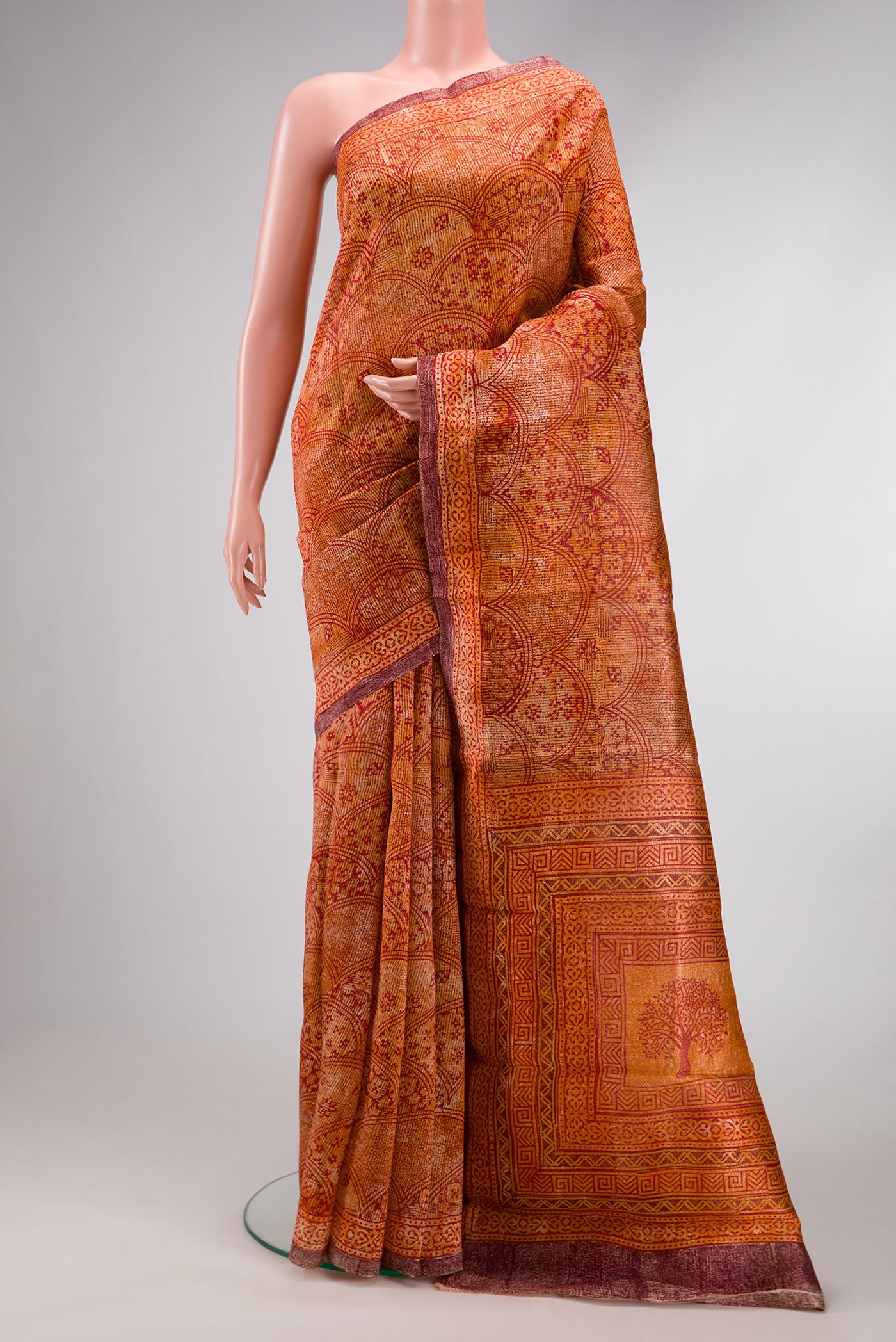 Orange Dual Tone Tussar Silk Saree with Printed design on the body and Printed Border.  displayed on a mannequin