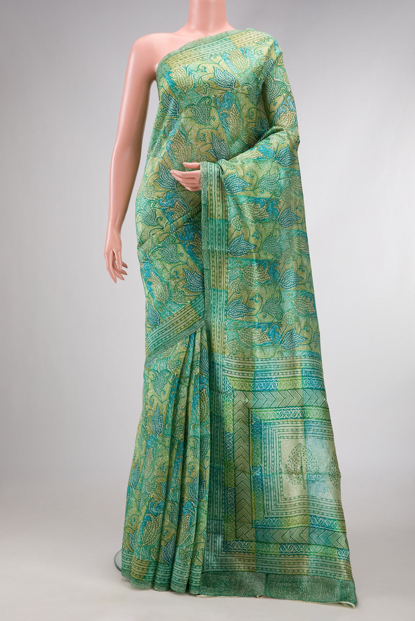 Pista Green Dual Tone Tussar Silk Saree with Printed design on the body and Printed Border.  displayed on a mannequin