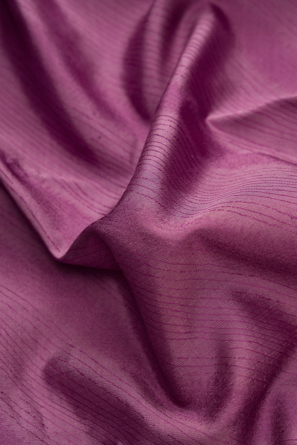 Close up of Burgundy Dual Tone Kanchipuram Silk Saree with Jacquard design on the body and Temple Border.  displaying folds