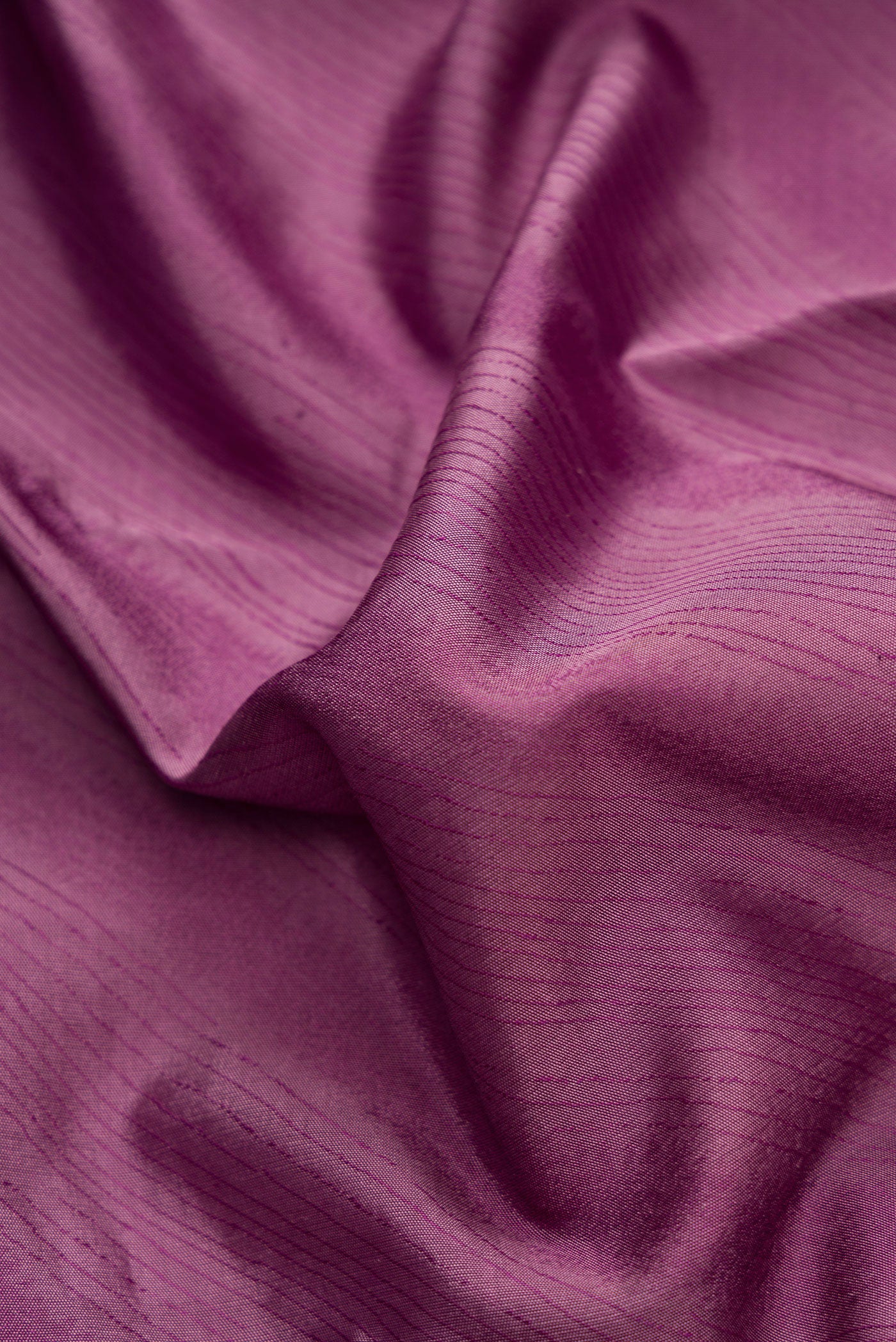 Close up of Burgundy Dual Tone Kanchipuram Silk Saree with Jacquard design on the body and Temple Border.  displaying folds