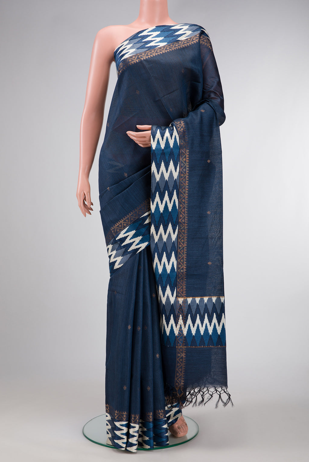 Navy Blue Dual Tone Tussar Silk Saree with Zari Butta on the body and Ikat Border.  displayed on a mannequin