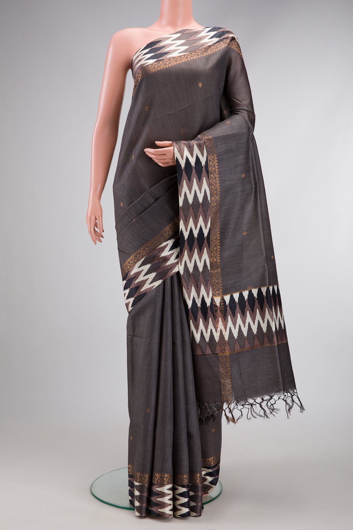 Grey Dual Tone Tussar Silk Saree with Zari Butta on the body and Ikat Border.  displayed on a mannequin