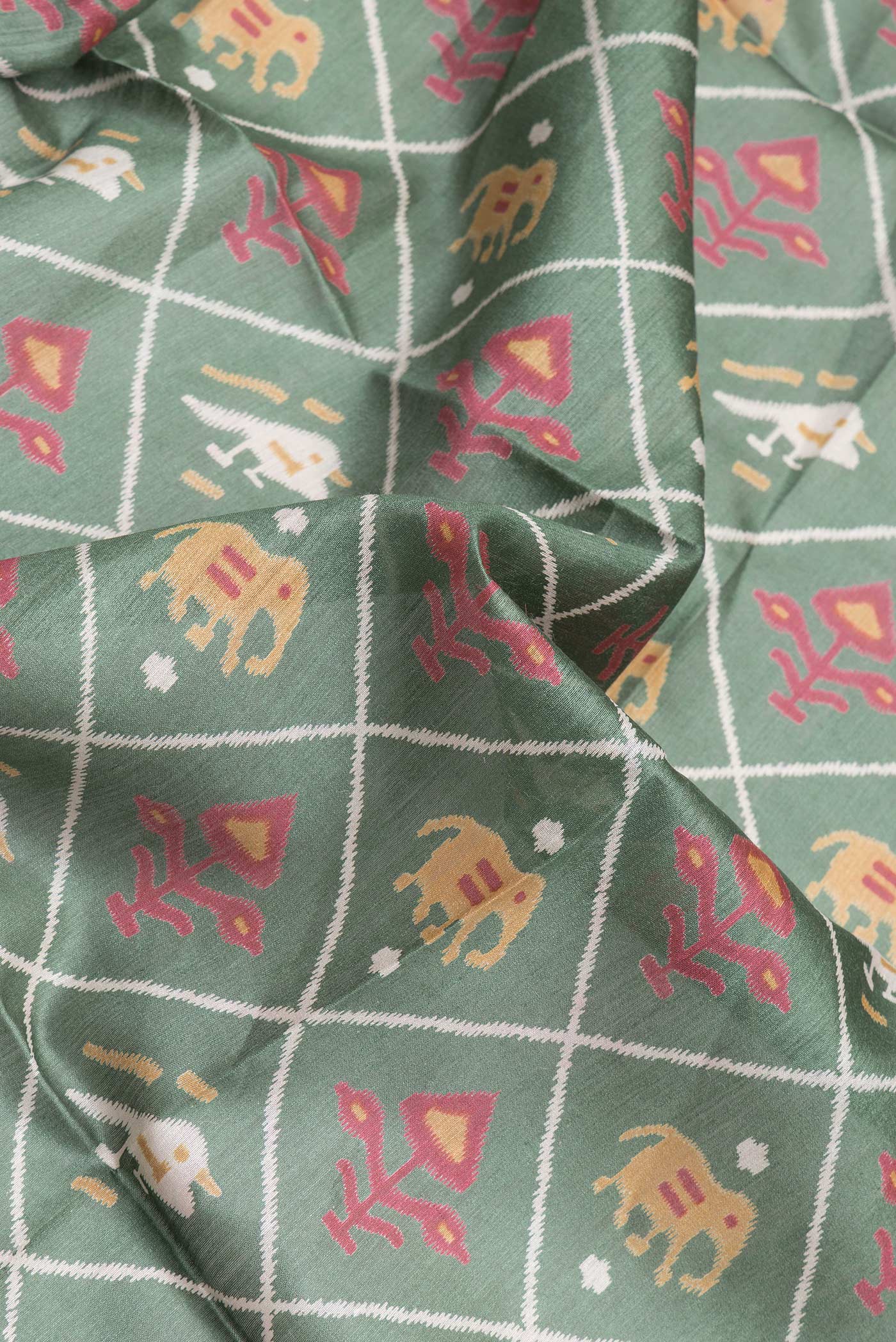 Close up of Green Dual Tone Tussar Silk Saree with Printed design on the body and Zari Border.  displaying folds