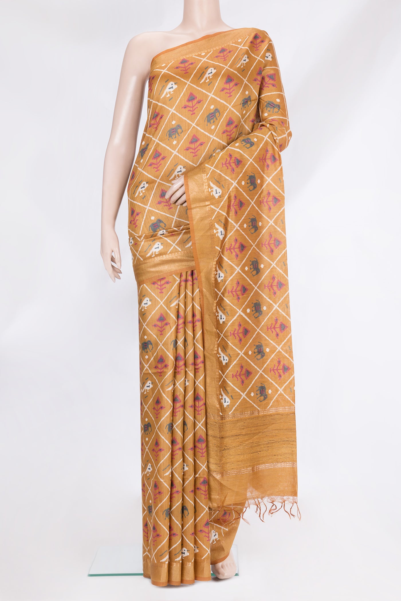 Gold Tussar Silk Saree with Ikat Print on the body and Zari Border.  displayed on a mannequin