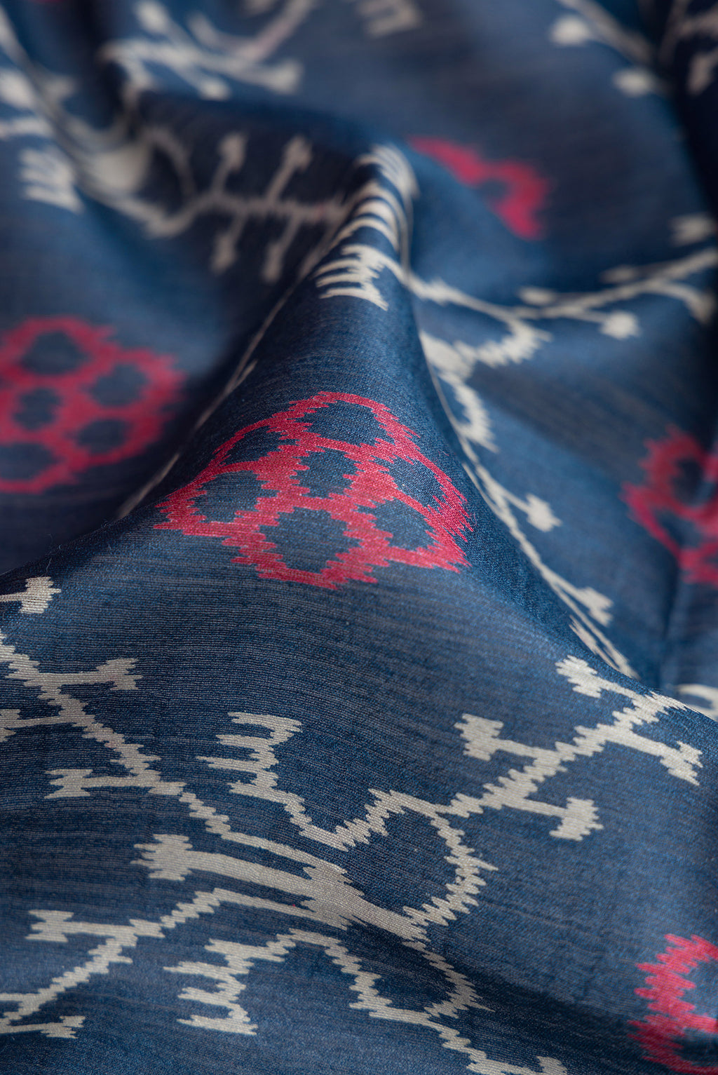 Close up of Navy Blue Dual Tone Tussar Silk Saree with Printed design on the body and Embroidery Border.  displaying folds