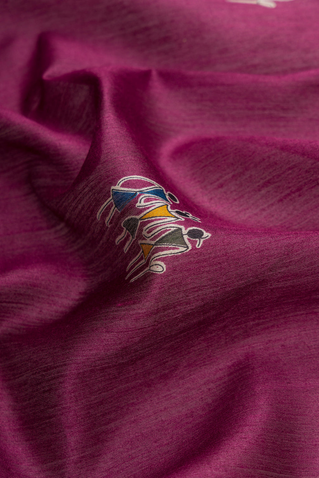 Close up of Burgundy Dual Tone Tussar Silk Saree with Printed design on the body and Ikat Border.  displaying folds