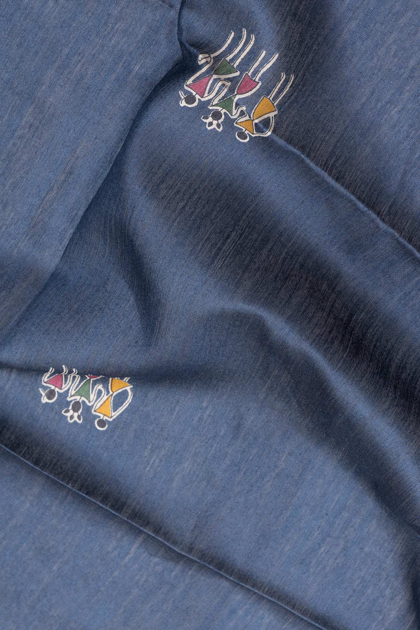 Close up of Navy Blue Dual Tone Tussar Silk Saree with Printed design on the body and Ikat Border.  displaying folds
