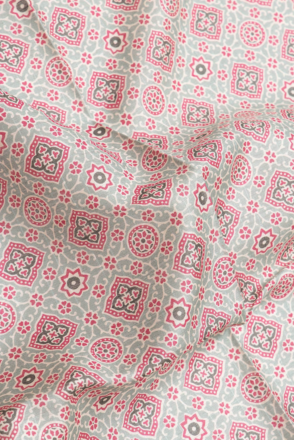 Close up of Green Dual Tone Tussar Silk Saree with Printed design on the body and Zari Border.  displaying folds