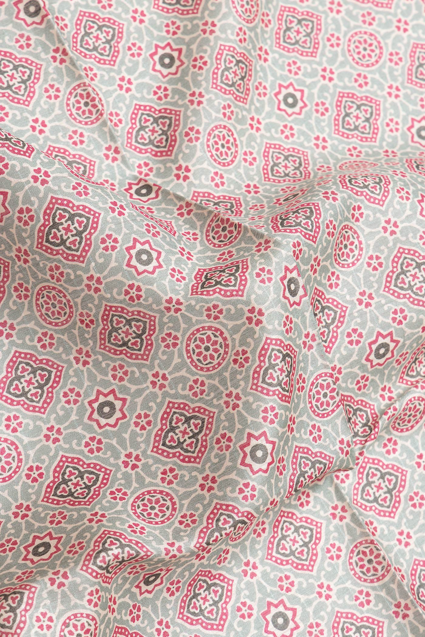 Close up of Green Dual Tone Tussar Silk Saree with Printed design on the body and Zari Border.  displaying folds