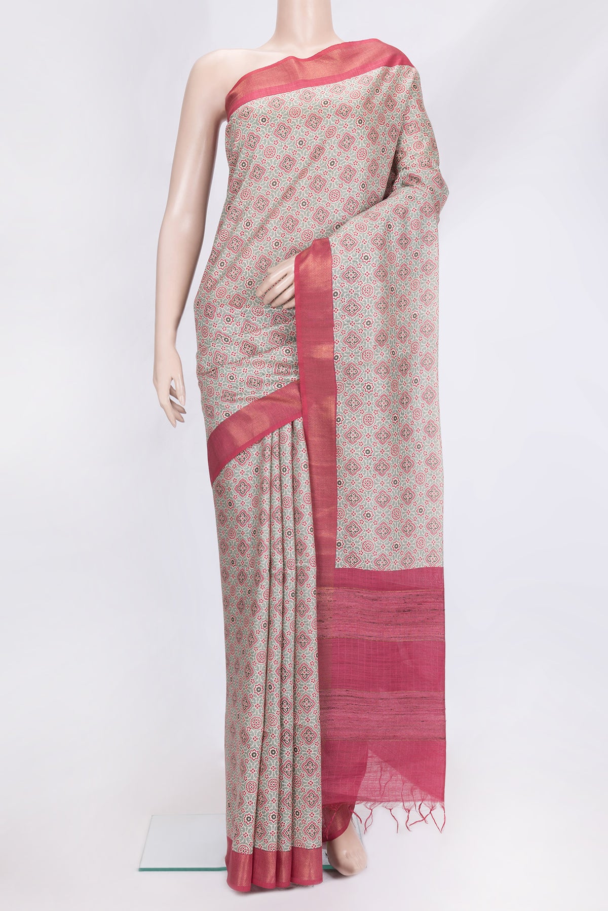 Green Dual Tone Tussar Silk Saree with Printed design on the body and Zari Border.  displayed on a mannequin