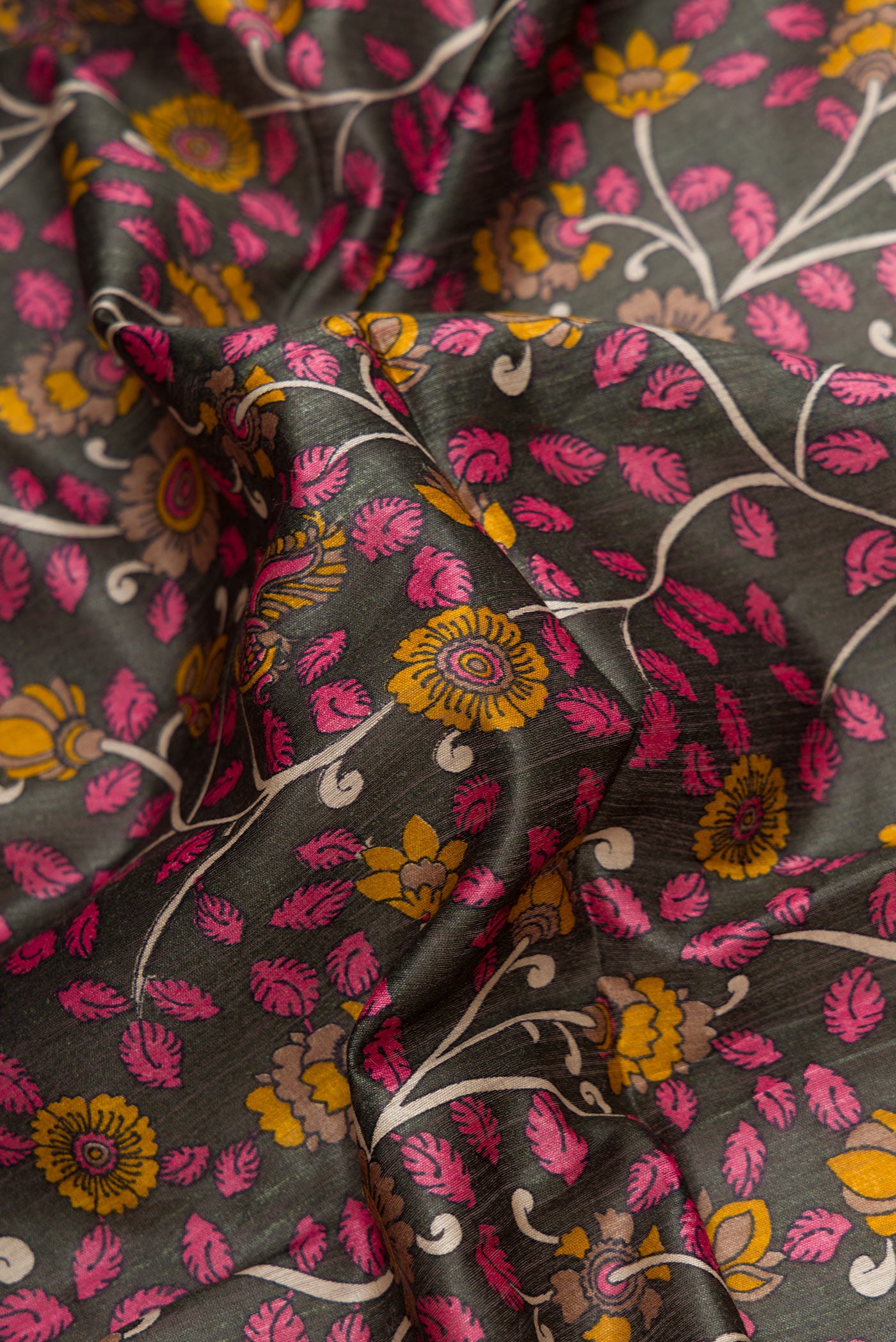 Close up of Bottle Green Dual Tone Tussar Silk Saree with Printed design on the body and Checks Border.  displaying folds
