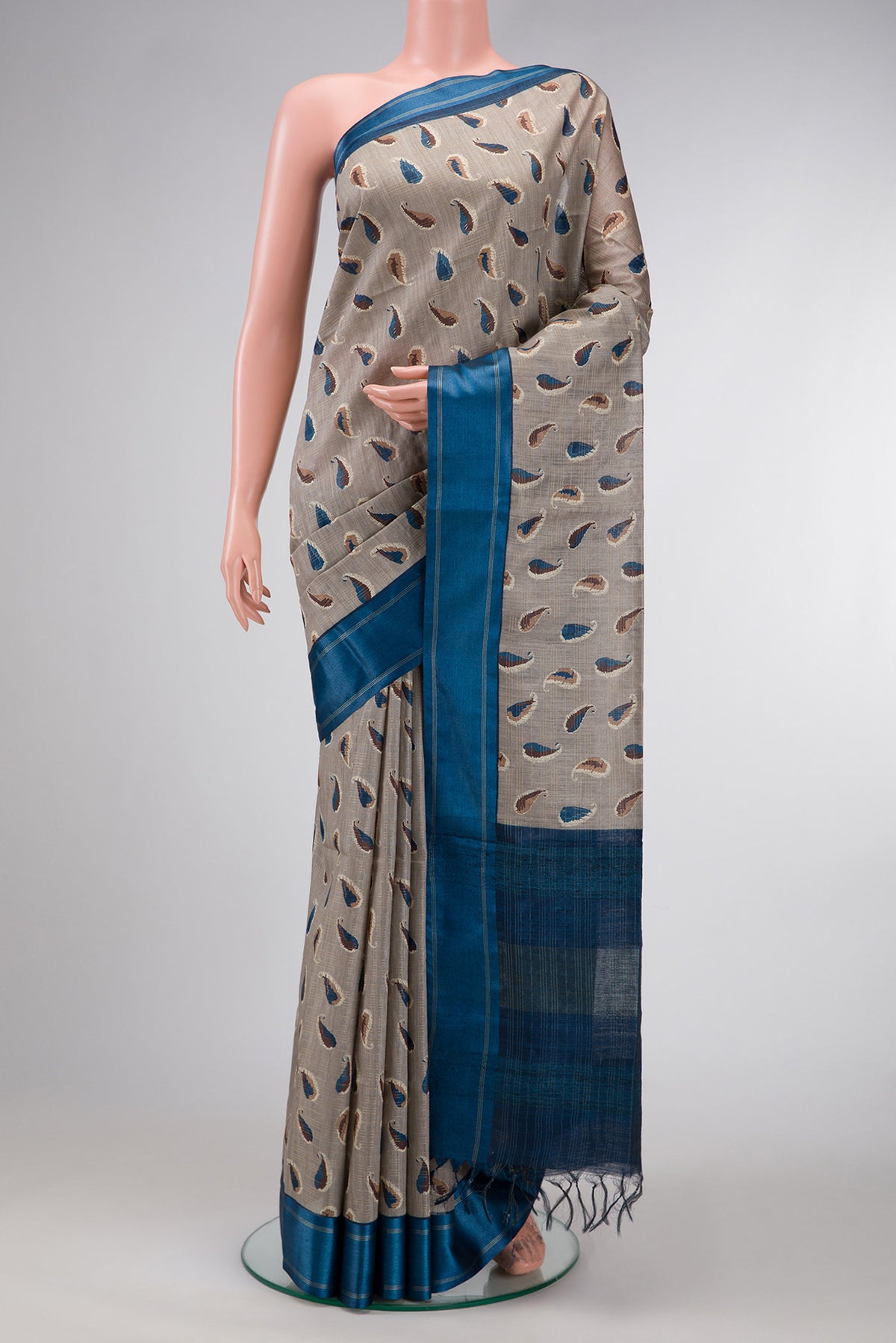 Grey Dual Tone Tussar Silk Saree with Printed design on the body and Zari Border.  displayed on a mannequin
