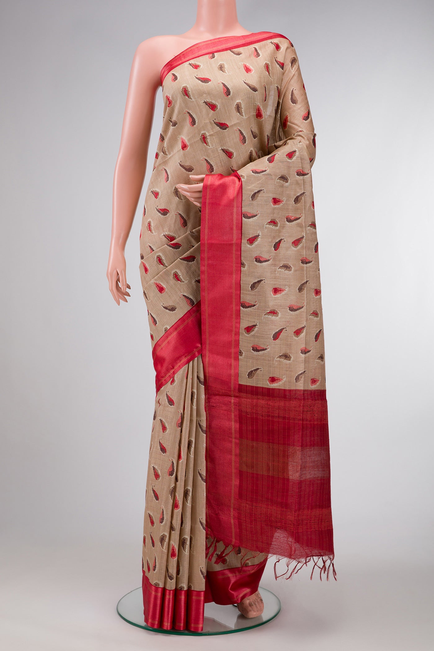 Beige Dual Tone Tussar Silk Saree with Printed design on the body and Zari Border.  displayed on a mannequin