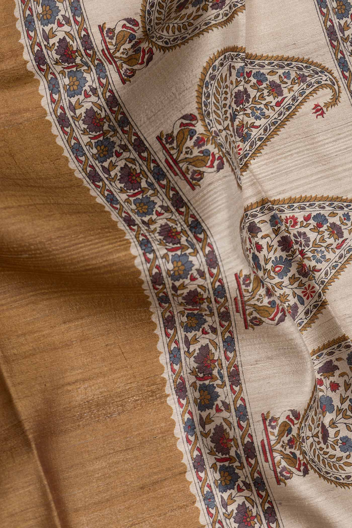 Close up of Mehandi Green Dual Tone Tussar Silk Saree with Printed design on the body and Fancy Border.  displaying folds