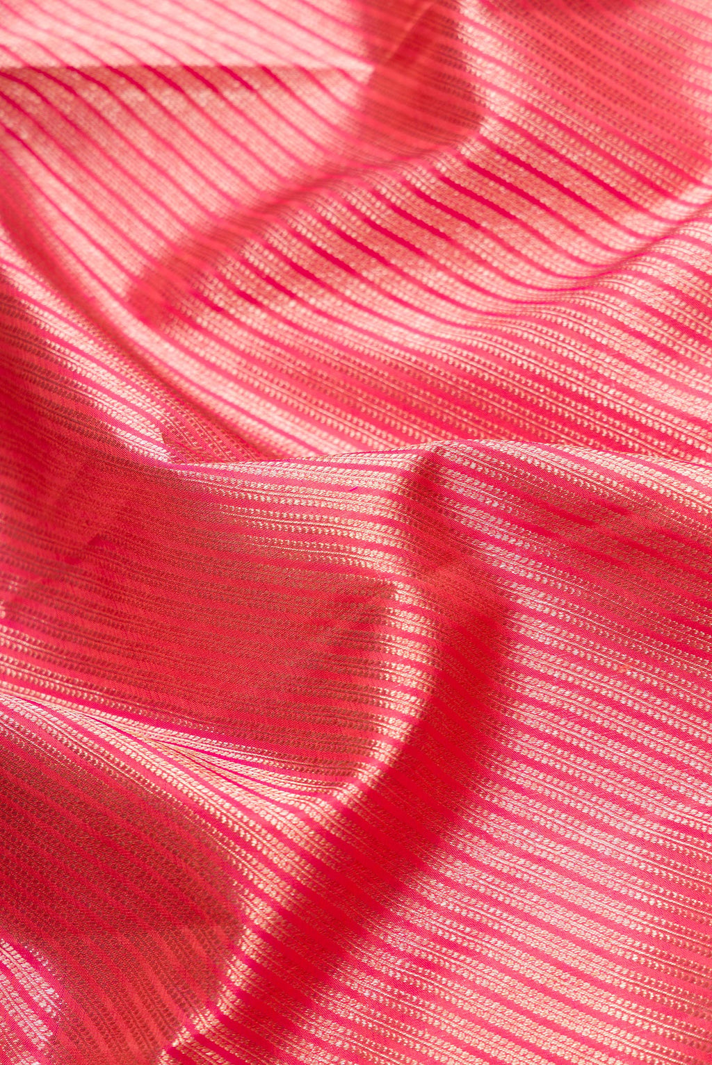 Close up of Orange Dual Tone Kanchipuram Silk Saree with Zari Brocade on the body and Zari Border.  displaying folds