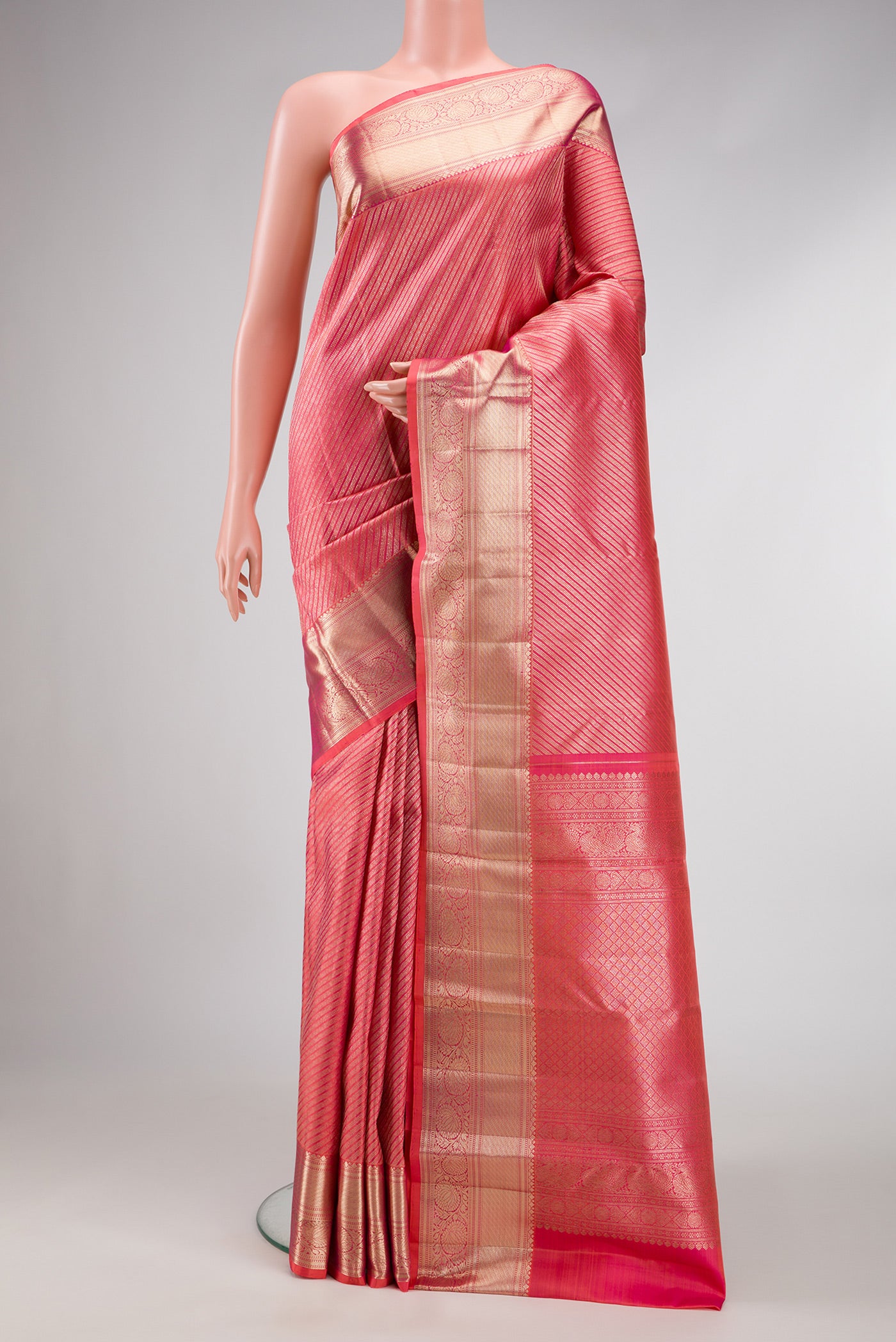 Orange Dual Tone Kanchipuram Silk Saree with Zari Brocade on the body and Zari Border.  displayed on a mannequin