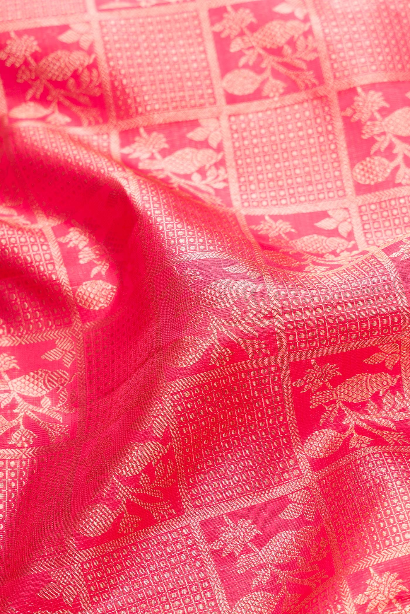 Close up of Pink Dual Tone Kanchipuram Silk Saree with Zari Brocade on the body and Zari Border.  displaying folds