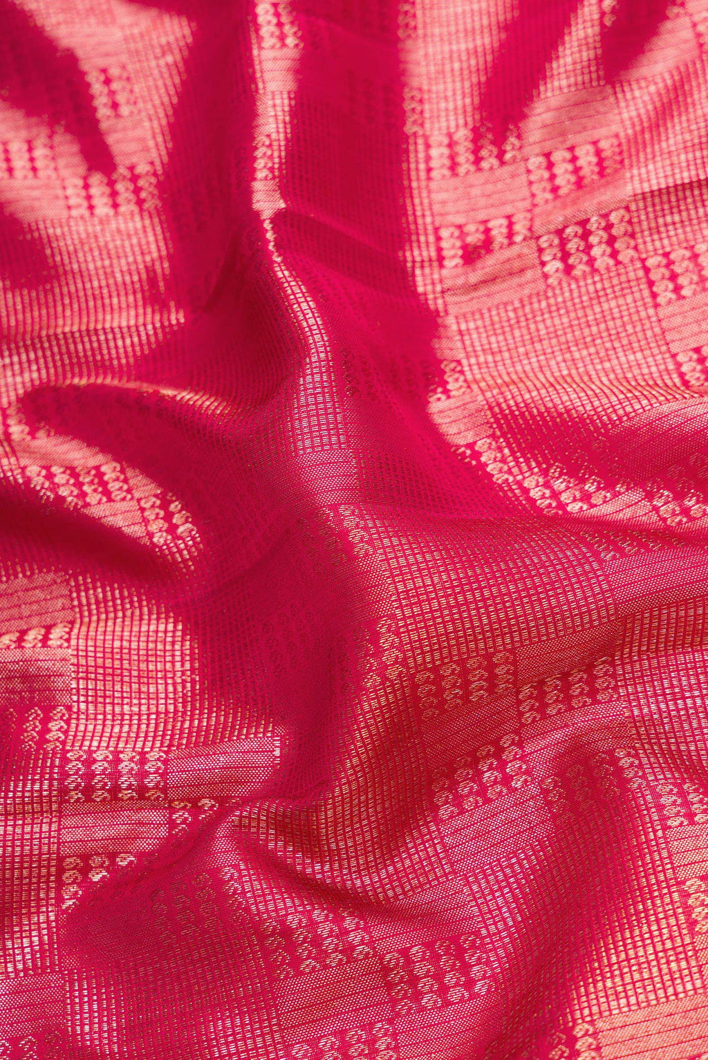 Close up of Maroon Dual Tone Kanchipuram Silk Saree with Zari Brocade on the body and Zari Border.  displaying folds