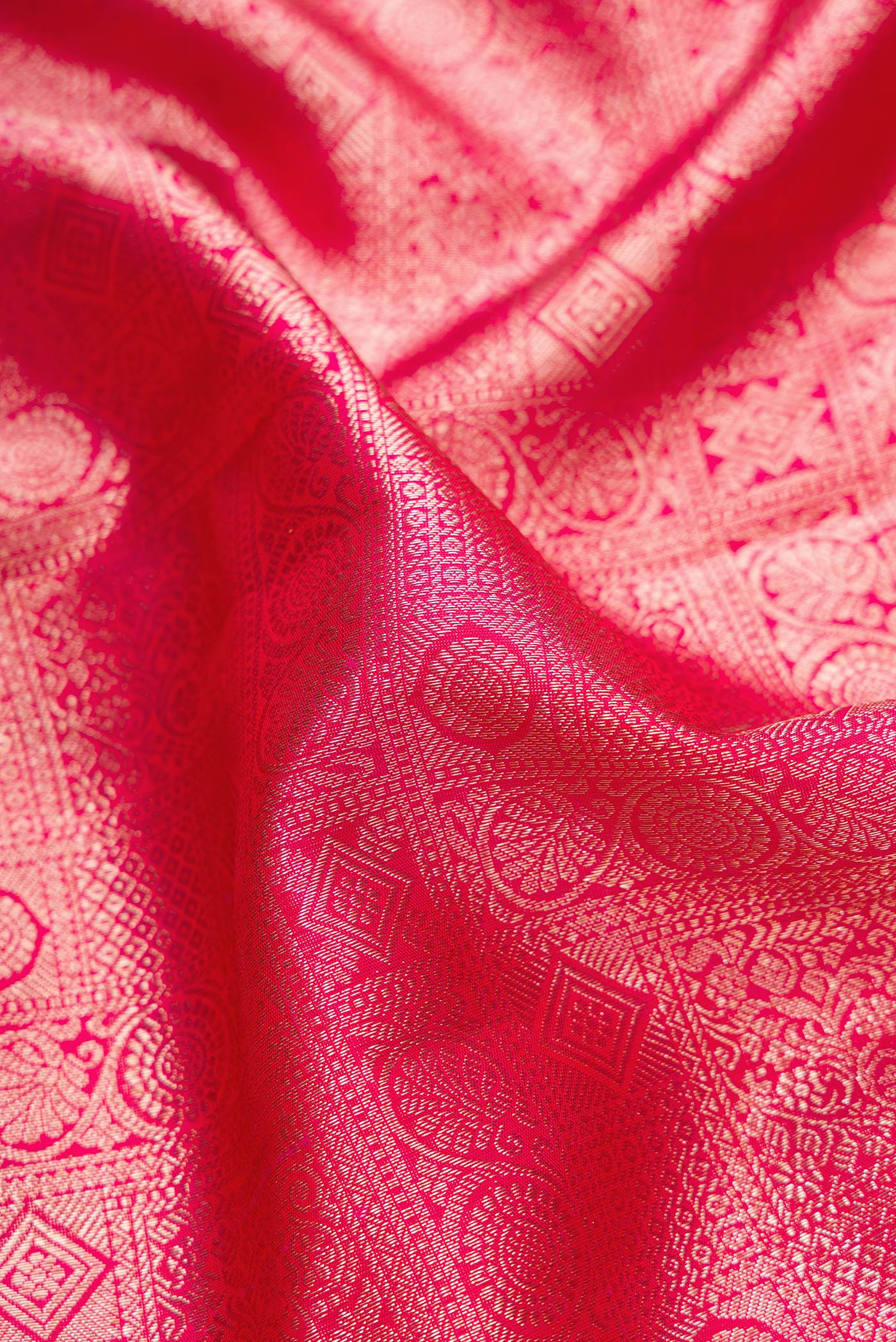 Close up of Pink Dual Tone Kanchipuram Silk Saree with Zari Brocade on the body and Zari Border.  displaying folds
