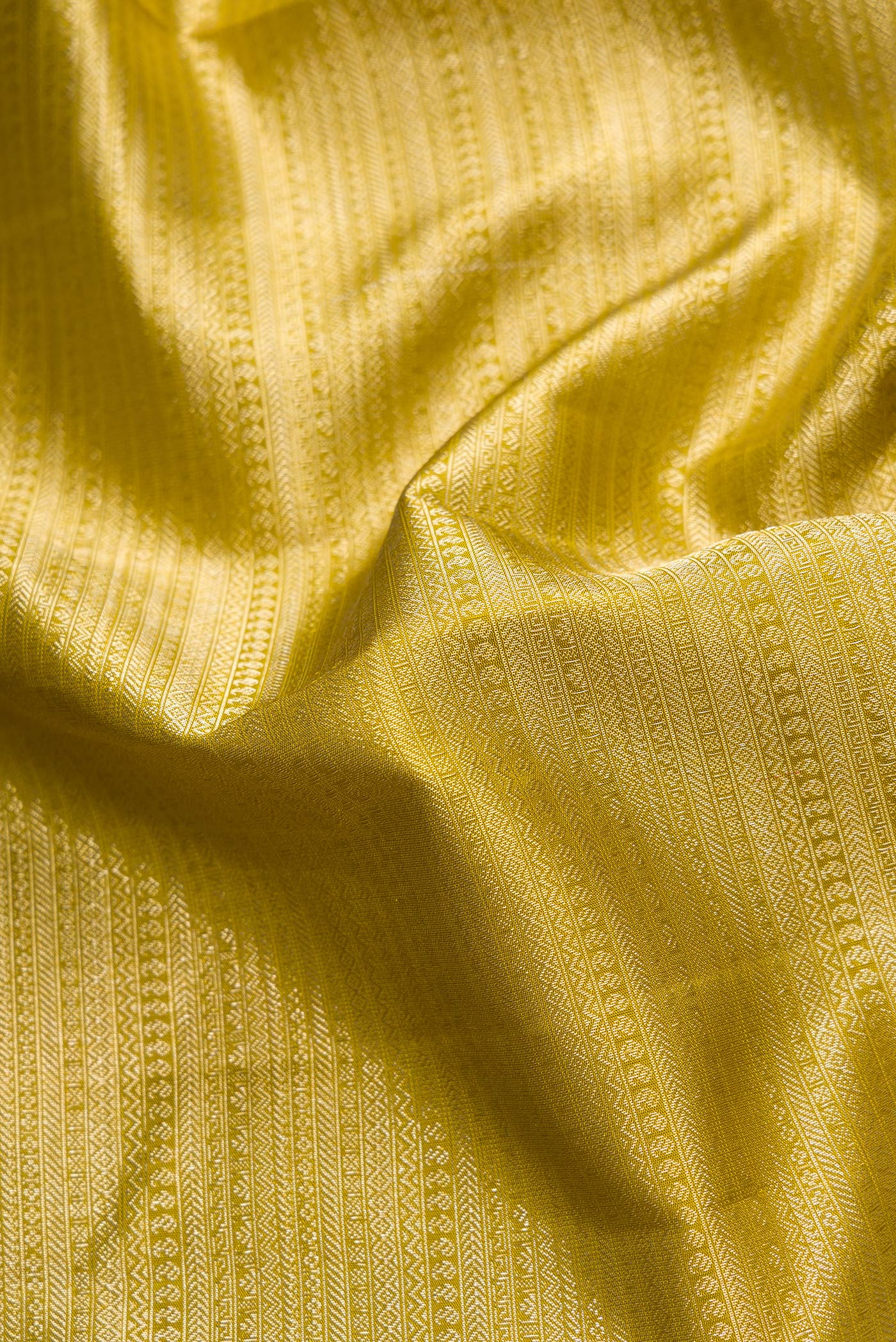 Close up of Mehandi Green Dual Tone Kanchipuram Silk Saree with Zari Brocade on the body and Zari Border.  displaying folds