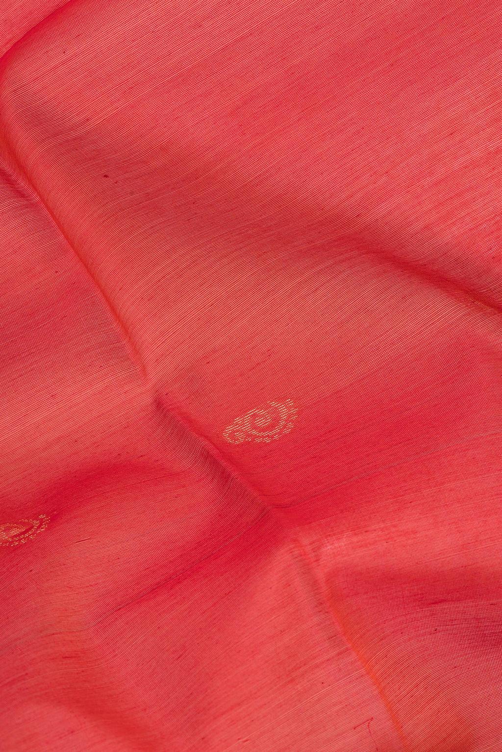 Close up of Red Silk Cotton Saree with Zari Butta on the body and Zari Border.  displaying folds