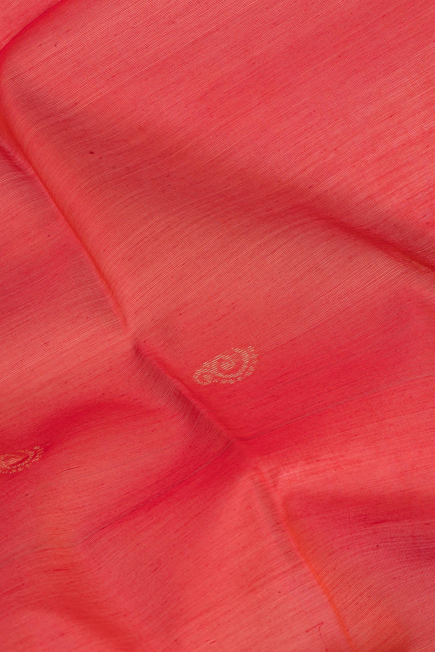 Close up of Red Silk Cotton Saree with Zari Butta on the body and Zari Border.  displaying folds