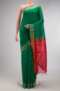 Green Silk Cotton Saree with Zari Butta on the body and Zari Border.  displayed on a mannequin
