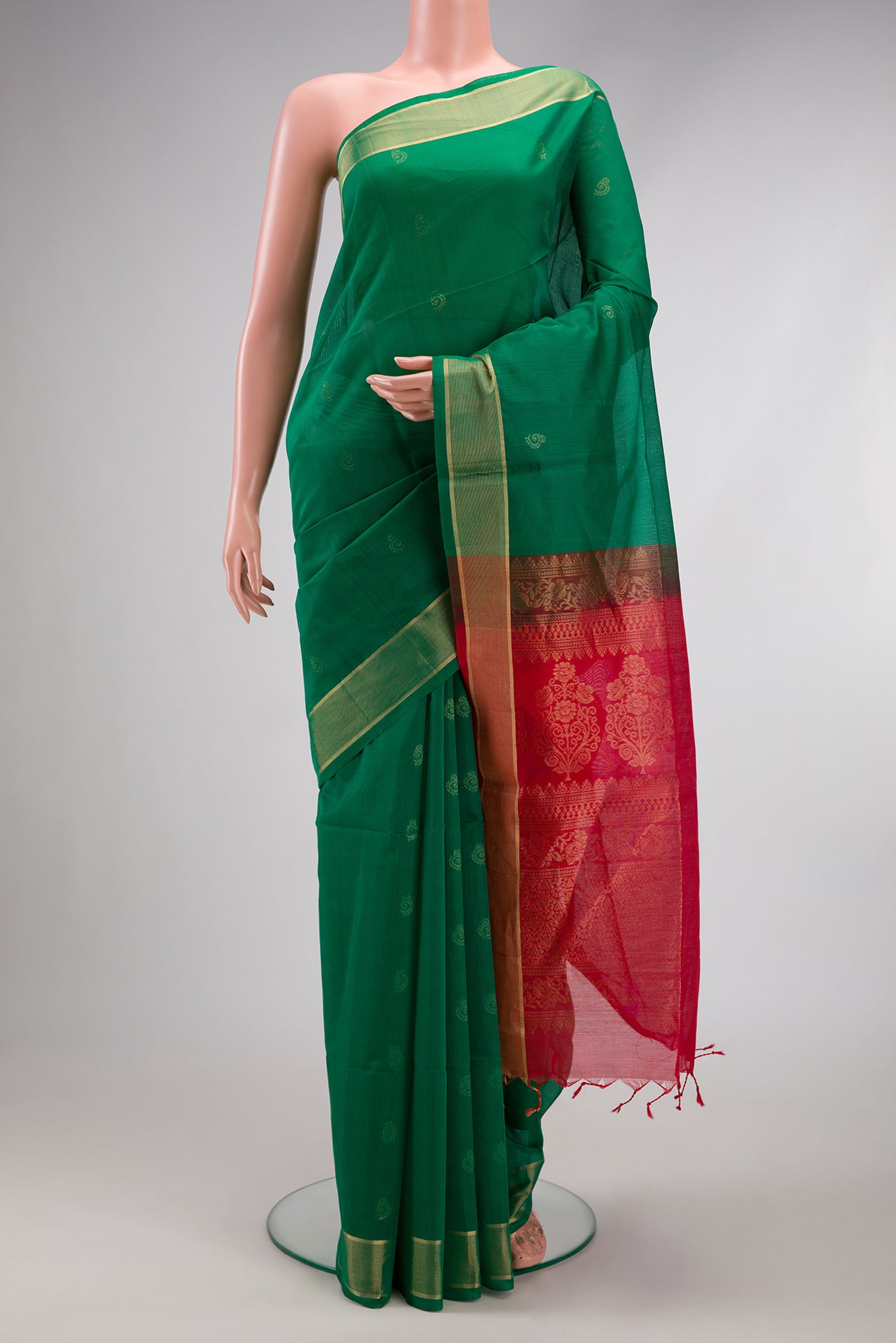 Green Silk Cotton Saree with Zari Butta on the body and Zari Border.  displayed on a mannequin