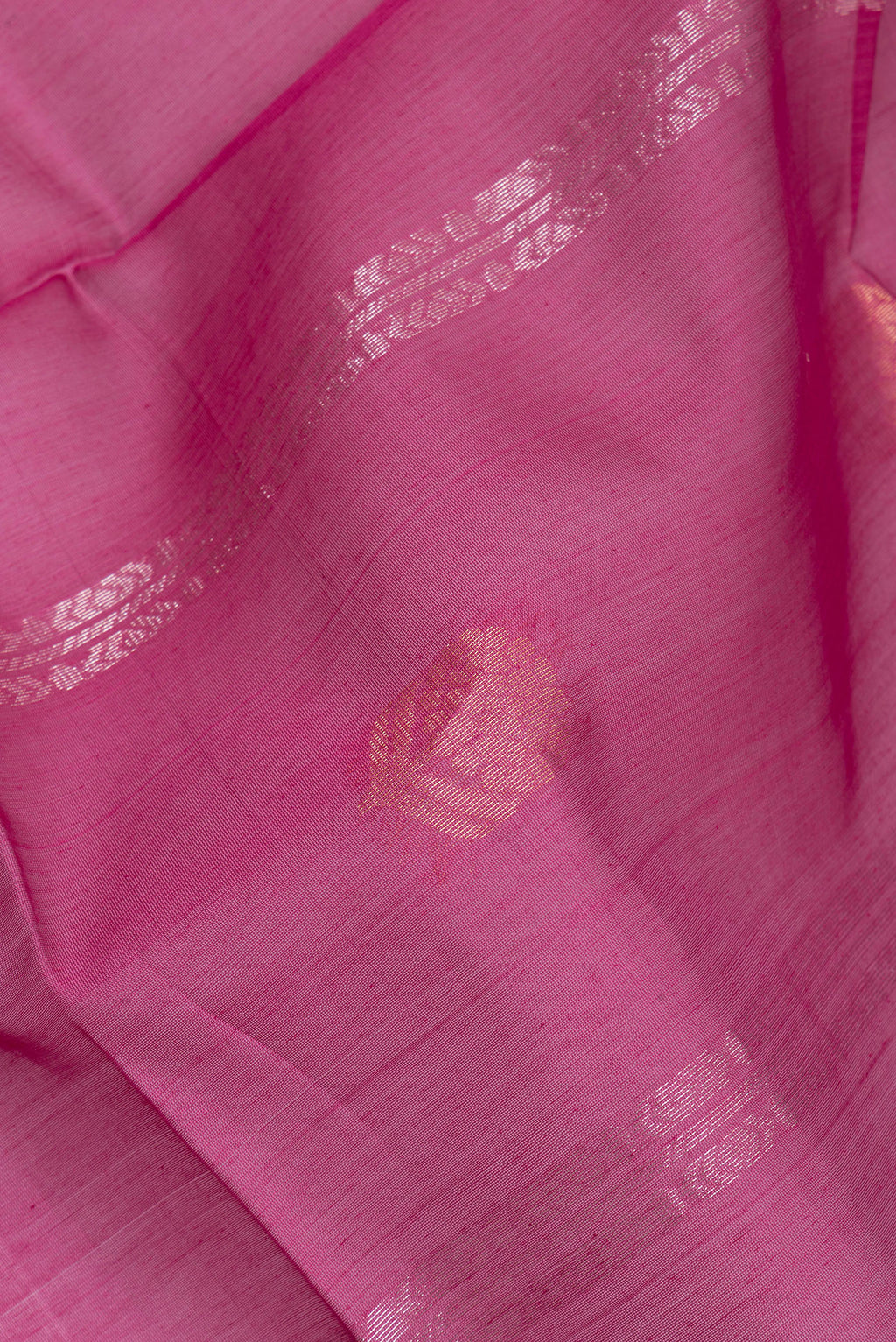 Close up of Magenta Silk Cotton Saree with Zari Butta on the body and Zari Border.  displaying folds