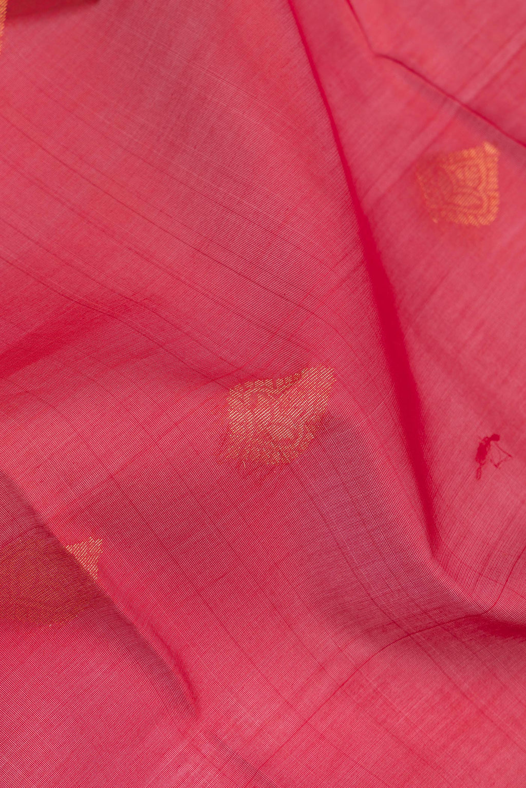 Close up of Red Silk Cotton Saree with Zari Butta on the body and Zari Border.  displaying folds