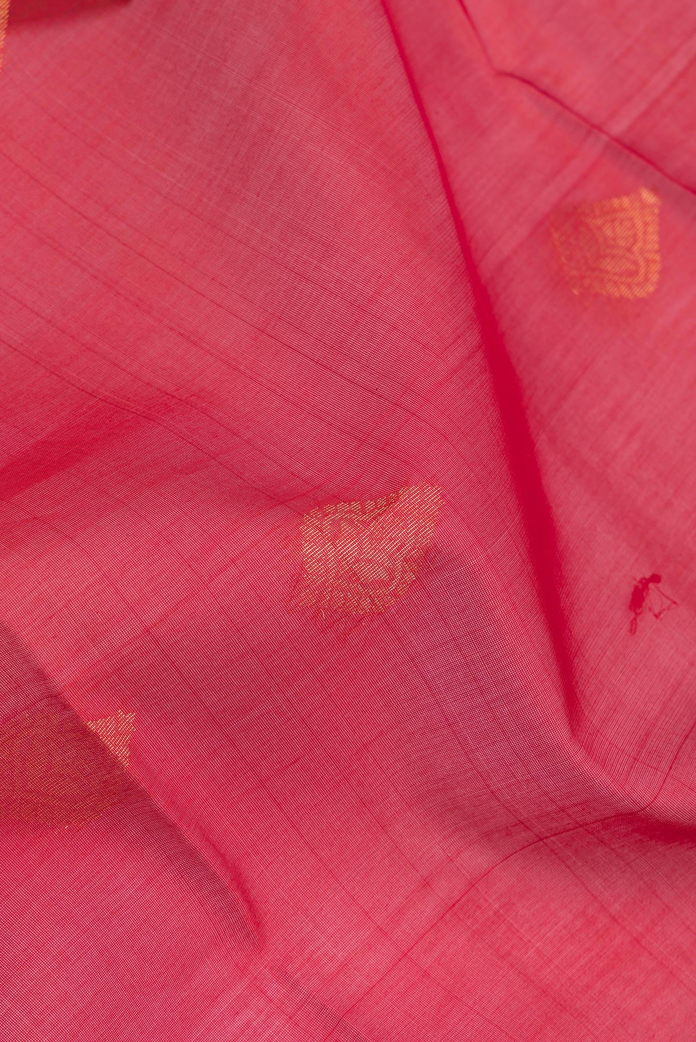 Close up of Red Silk Cotton Saree with Zari Butta on the body and Zari Border.  displaying folds