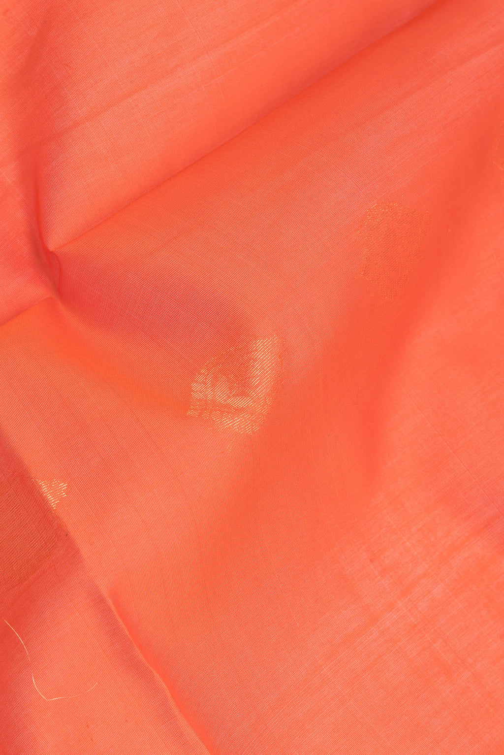 Close up of Orange Silk Cotton Saree with Zari Butta on the body and Zari Border.  displaying folds