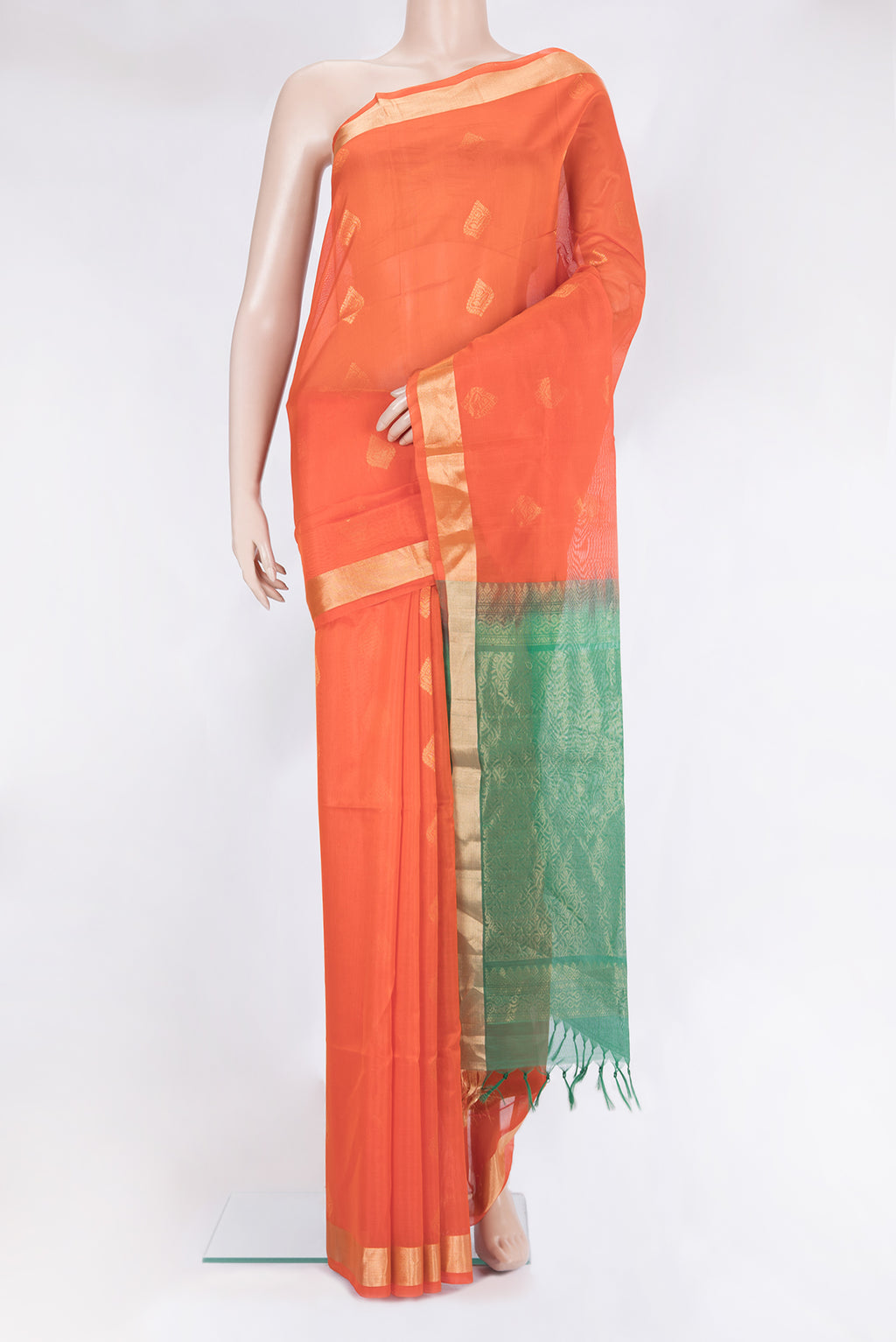 Orange Silk Cotton Saree with Zari Butta on the body and Zari Border.  displayed on a mannequin