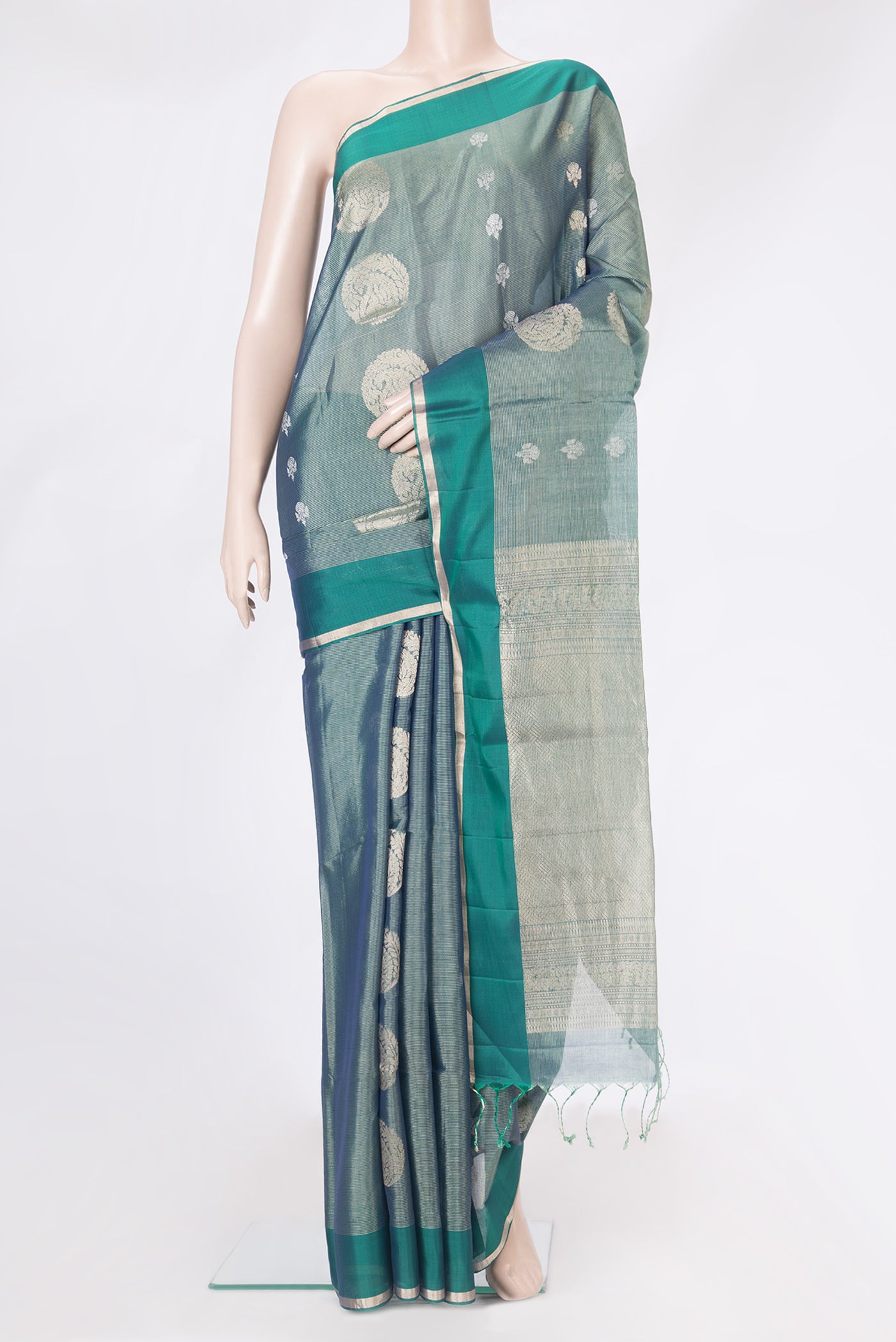Peacock Blue Dual Tone Silk Cotton Saree with Zari Butta on the body and Zari Border.  displayed on a mannequin