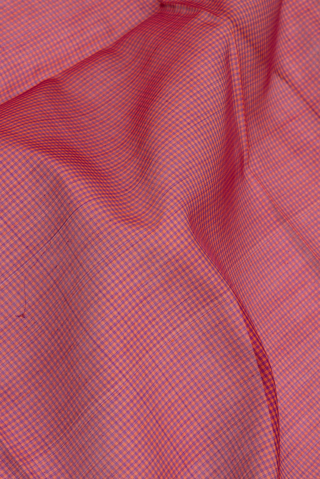 Close up of Orange Silk Cotton Saree with Checked design on the body and Zari Border.  displaying folds