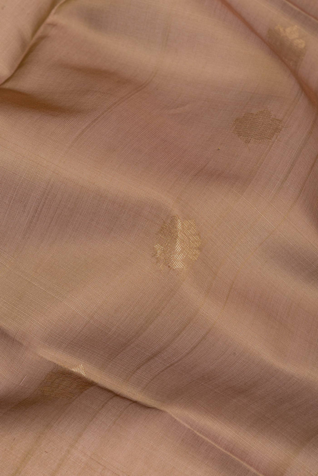 Close up of Brown Silk Cotton Saree with Zari Butta on the body and Zari Border.  displaying folds