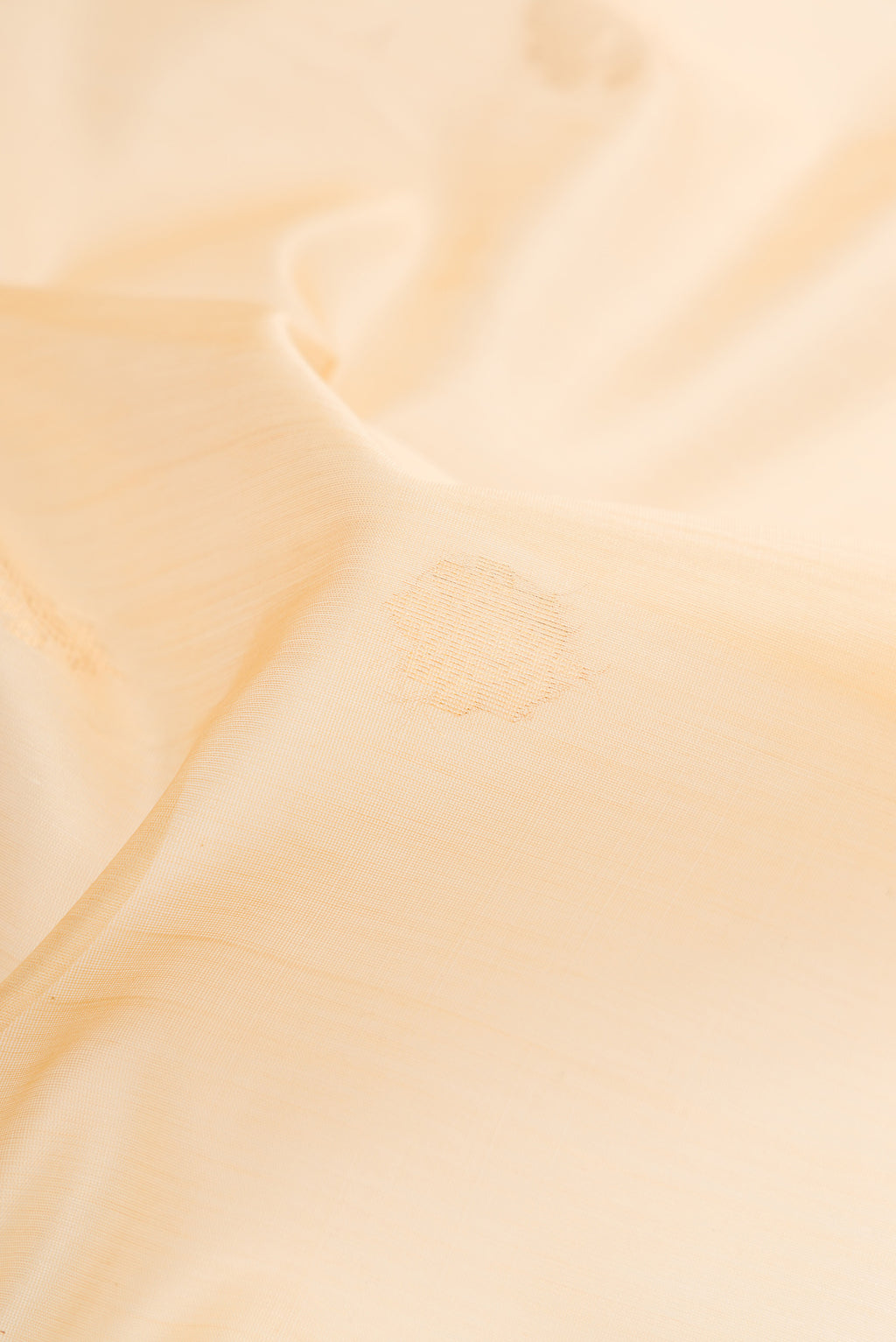 Close up of Sandal Silk Cotton Saree with Zari Butta on the body and Zari Border.  displaying folds