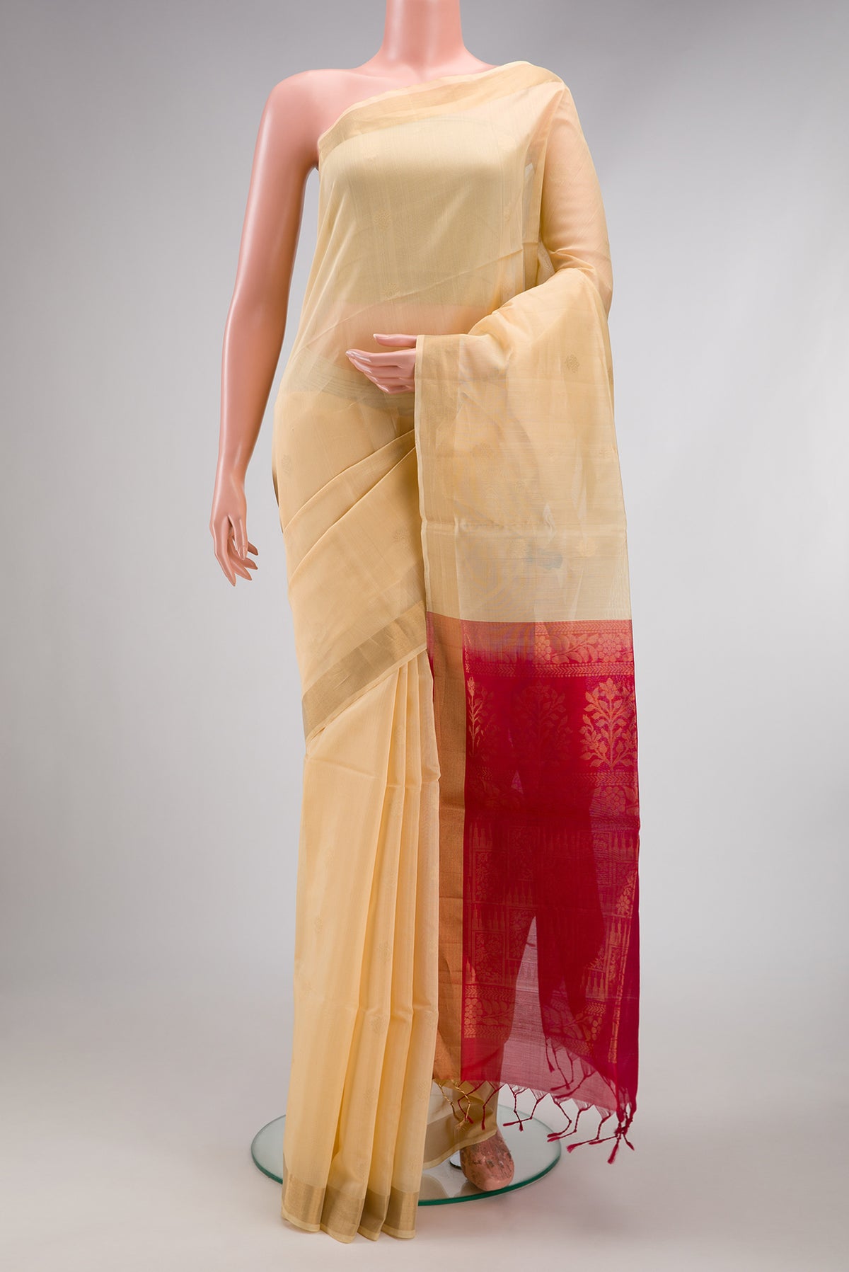 Sandal Silk Cotton Saree with Zari Butta on the body and Zari Border.  displayed on a mannequin