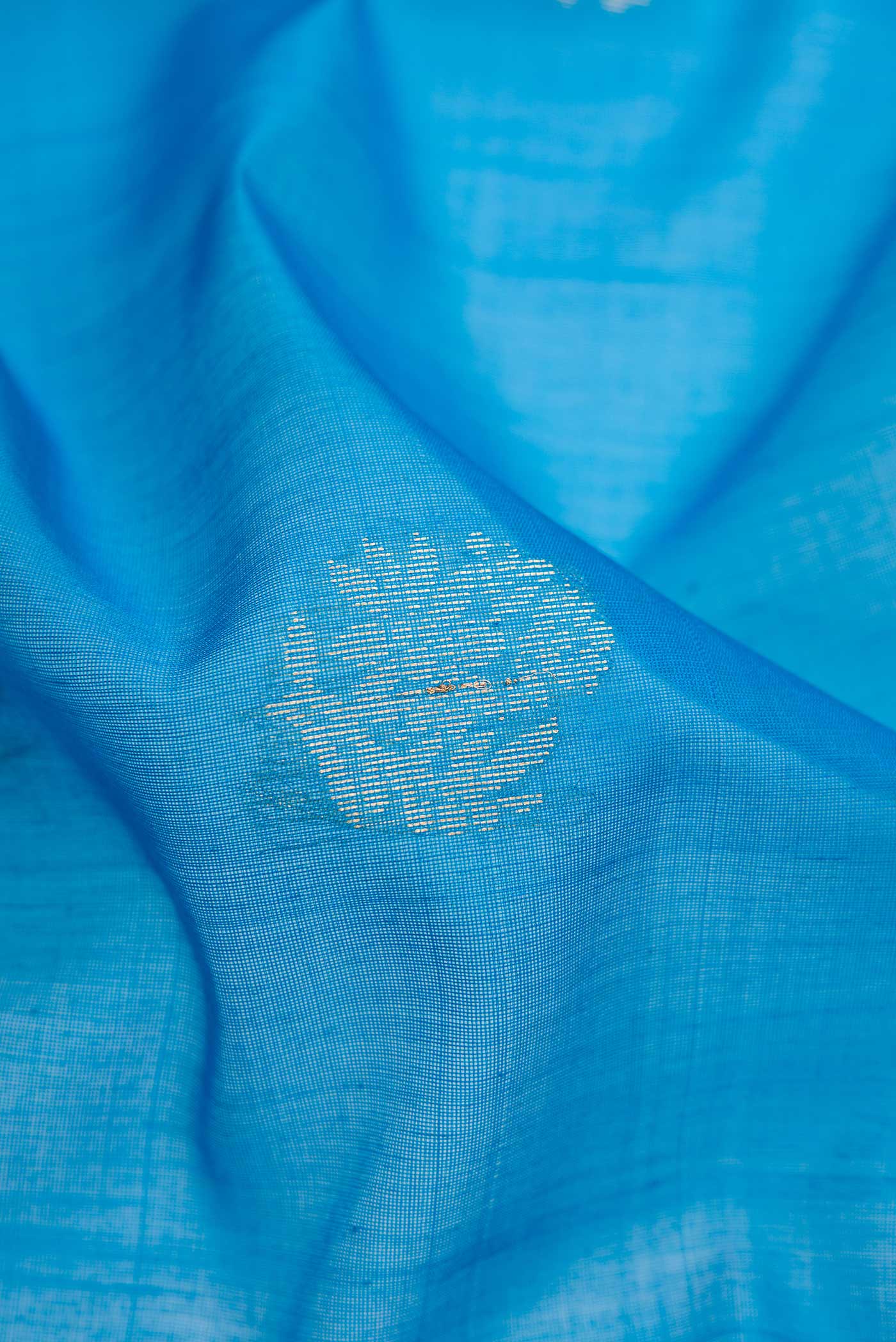 Close up of Sky Blue Dual Tone Silk Cotton Saree with Zari Butta on the body and Zari Border.  displaying folds