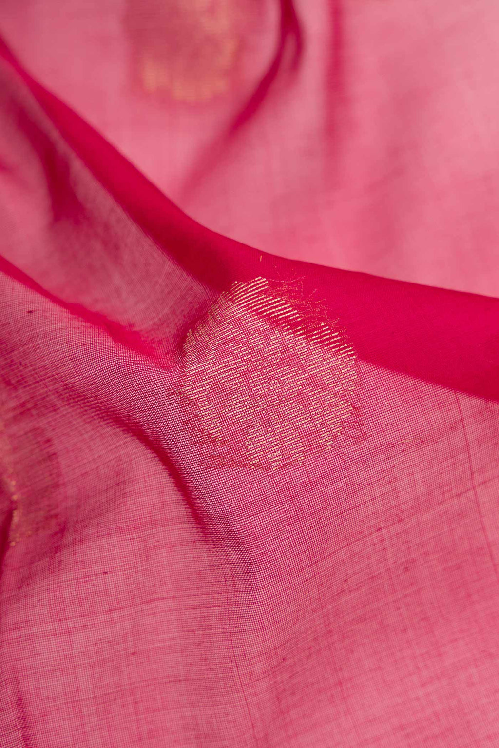 Close up of Maroon Dual Tone Silk Cotton Saree with Zari Butta on the body and Zari Border.  displaying folds
