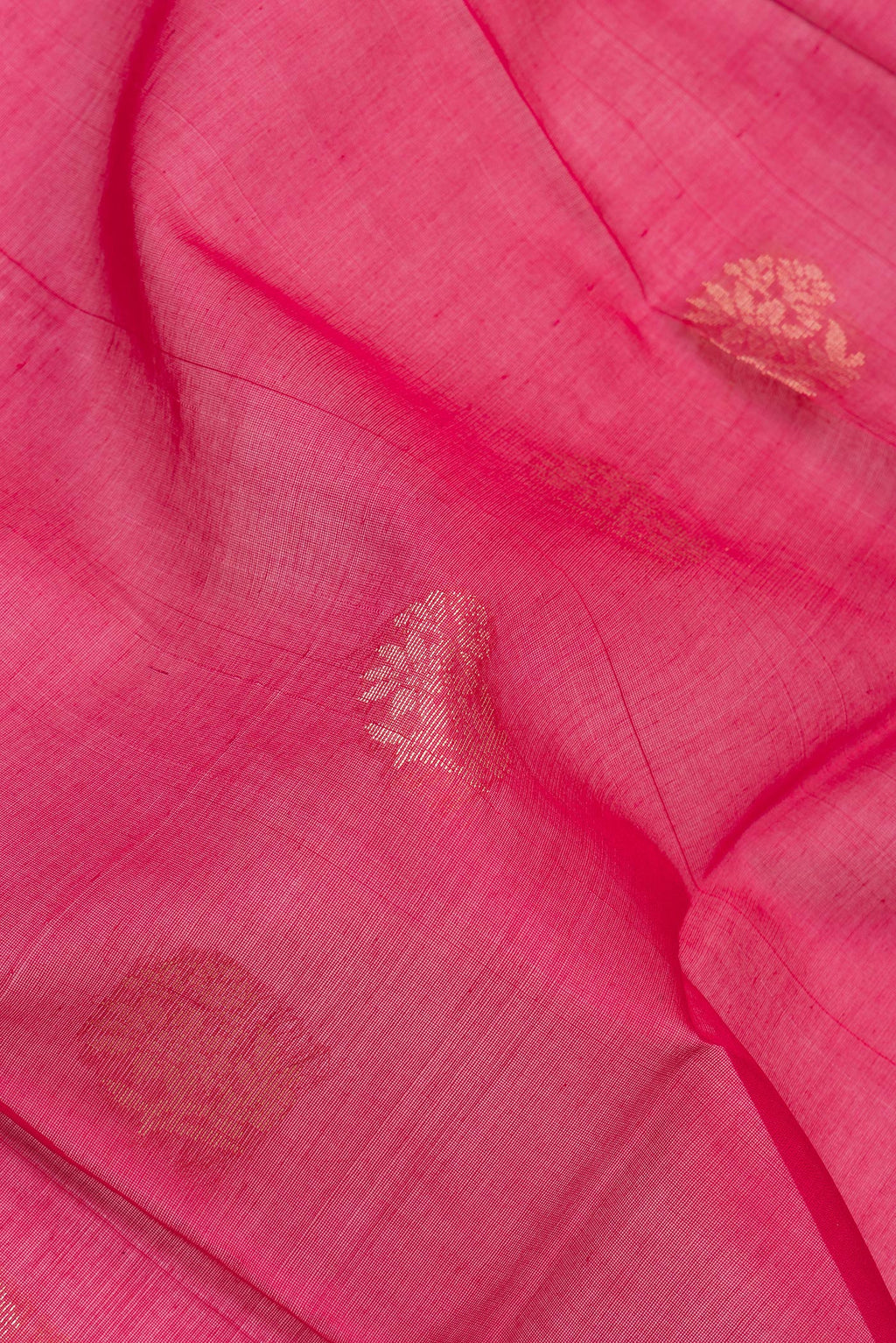 Close up of Dark Pink Silk Cotton Saree with Zari Butta on the body and Zari Border.  displaying folds