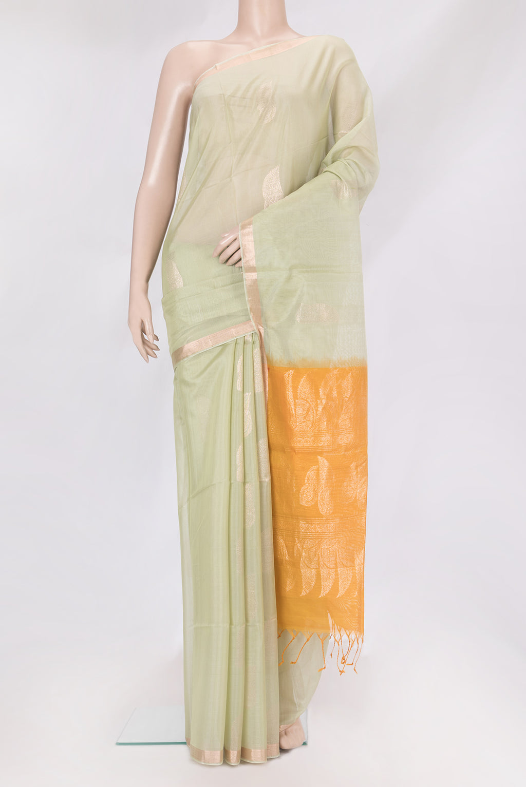 Pista Green Silk Cotton Saree with Zari Butta on the body and Zari Border.  displayed on a mannequin