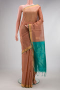 Rose Gold Silk Cotton Saree with Zari Butta on the body and Zari Border.  displayed on a mannequin
